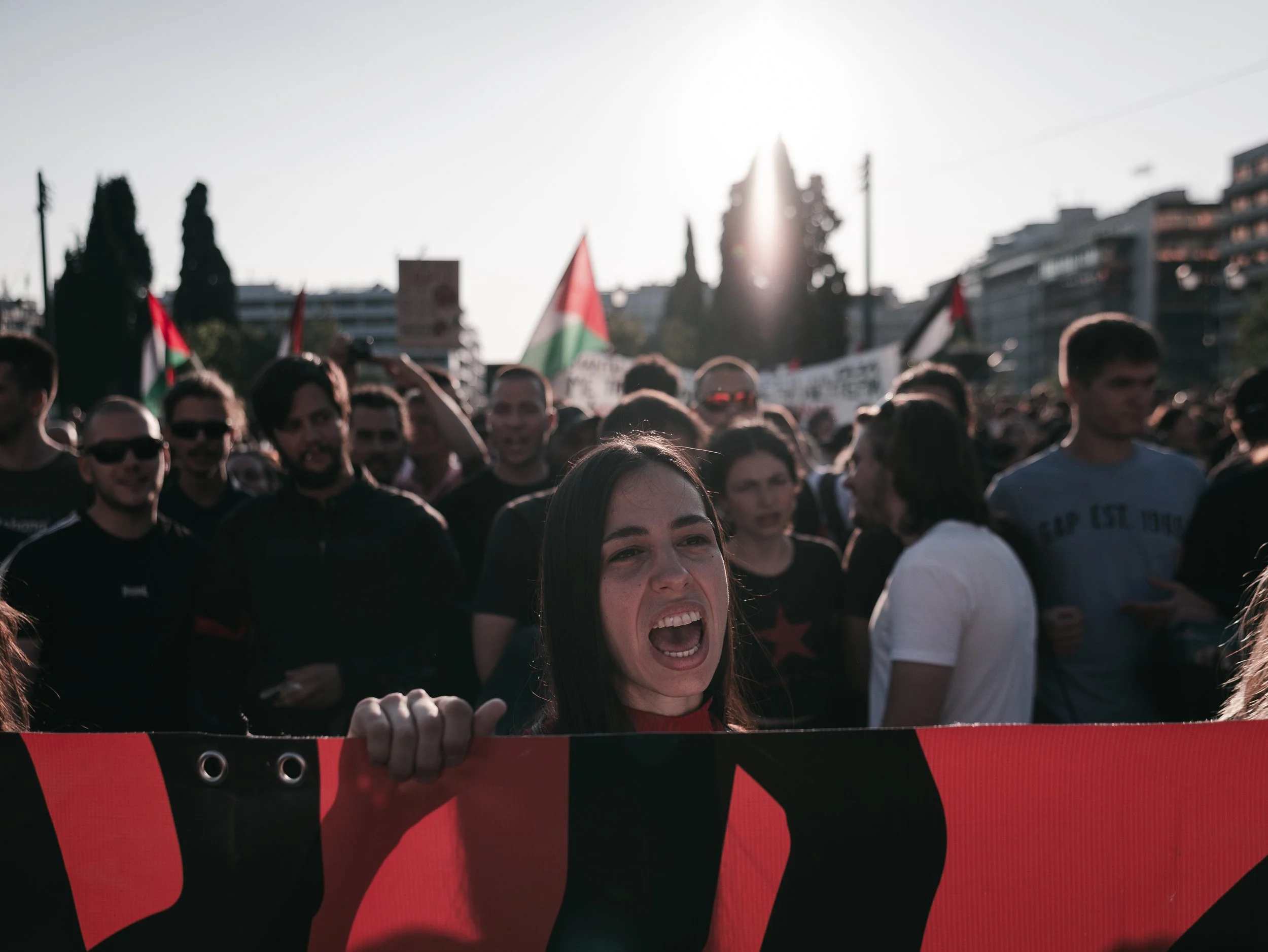 A girl shouts while holding a banner in Athens, Greece on June 15, 2025. The protest was organized in solidarity with Palestinians, drawing demonstrators to voice their support.