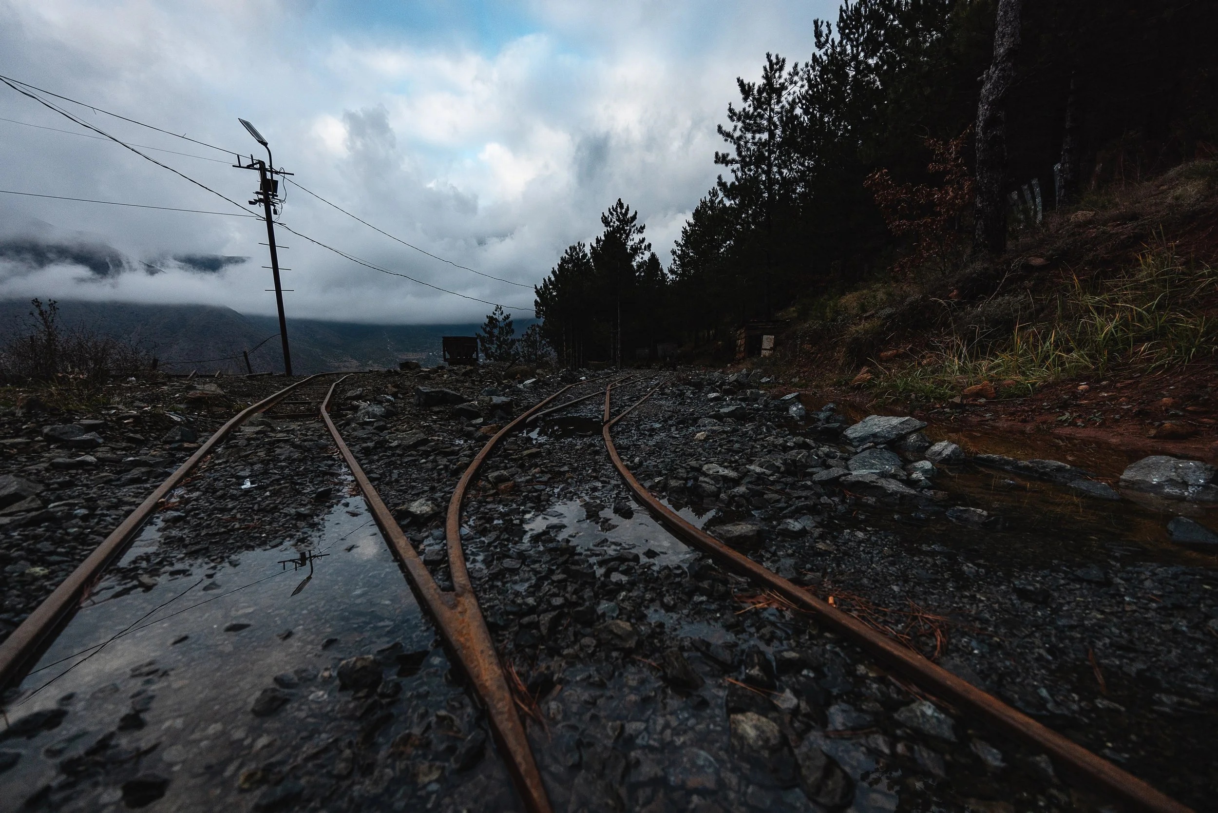 Old, rusted rails lie unused near the mine in Bulqizë, Dibër County, Albania on November 11, 2025. They are remnants of the mining infrastructure that once supported the transportation of chromium ore in the area.