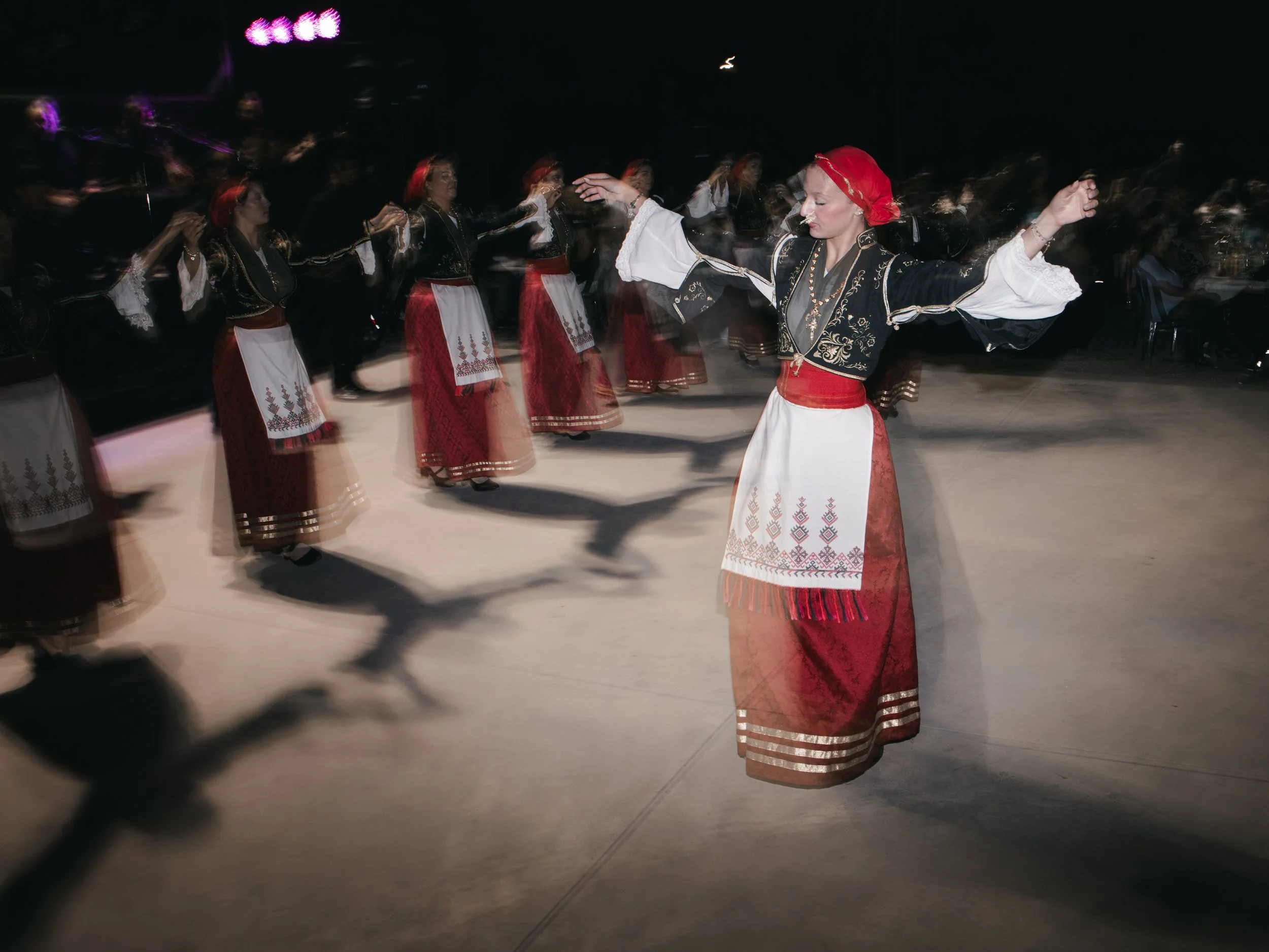 Women in traditional Cretan costumes dance during a panigiri, a village festival featuring music, food and dance that is rooted in Orthodox religious celebrations and local traditions. Skines, Crete, Greece, August 21, 2025.