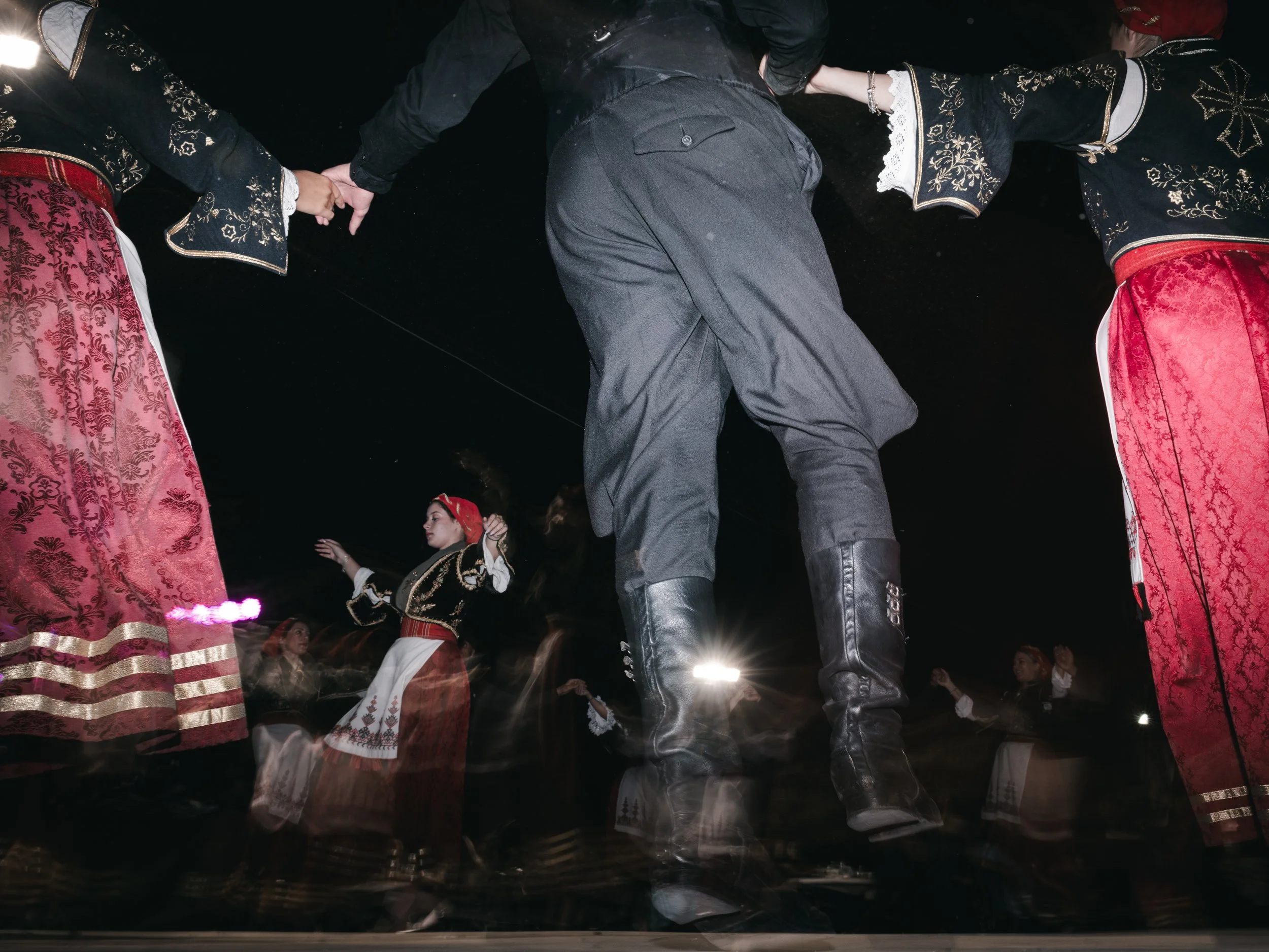 Men and women dance during a panigiri, a village festival featuring music, food and dance that is rooted in Orthodox religious celebrations and local traditions. Skines, Crete, Greece, August 21, 2025.
