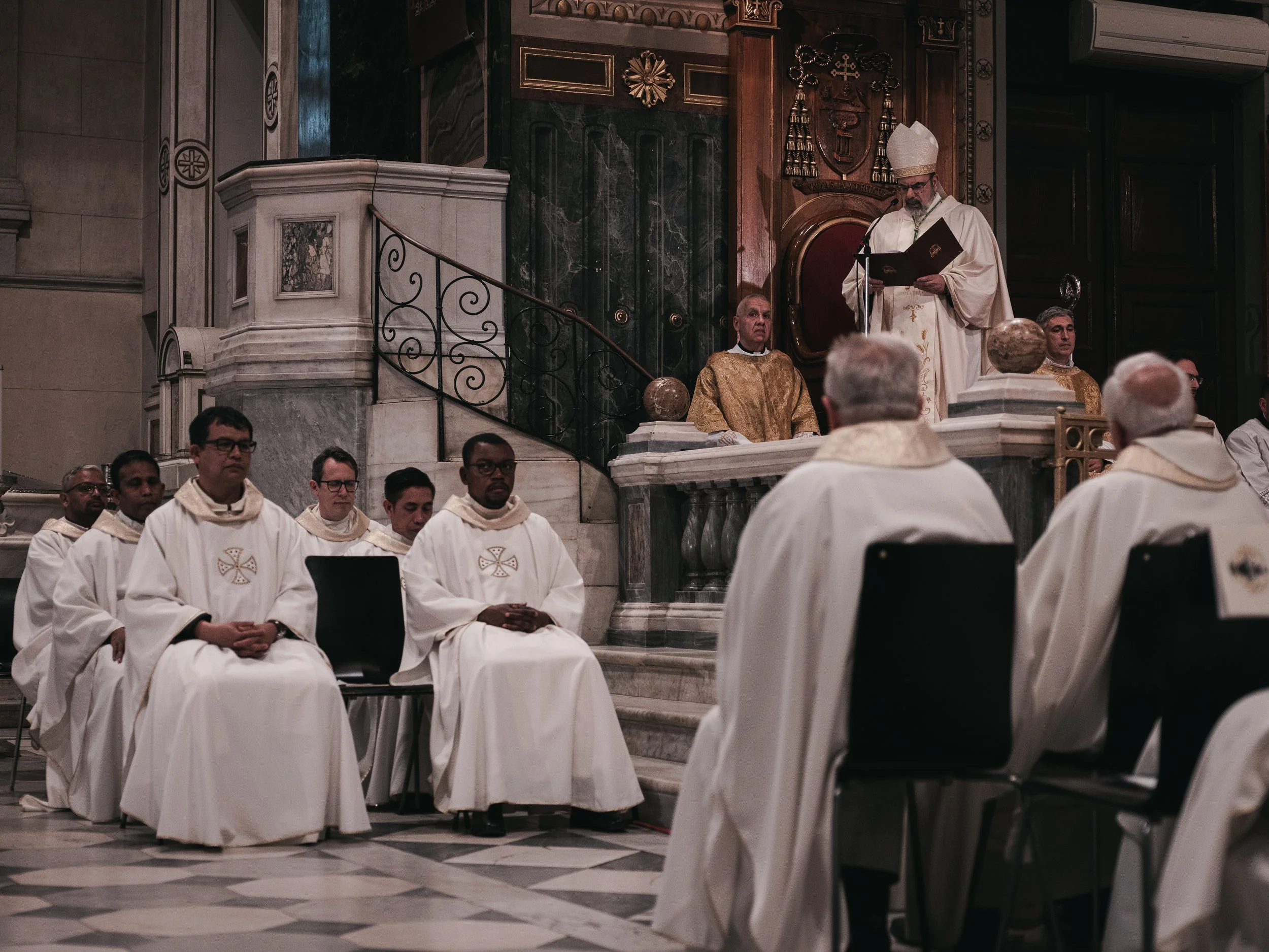 The parish priest along with other priests, leads mourners in prayer in remembrance of Pope Francis at the Basilica of Saint Dionysius the Areopagite in Athens, Greece, April 25, 2025.