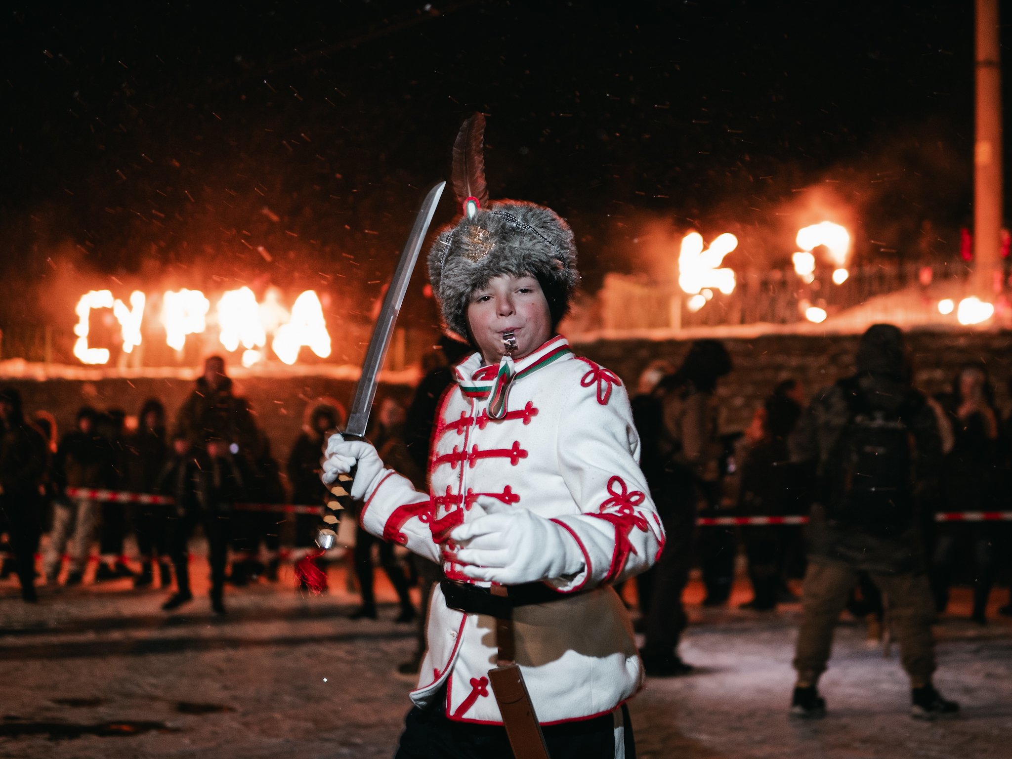 A young participant in full parade attire marks the opening of Surva in Kosharevo, celebrating cultural heritage and community tradition.