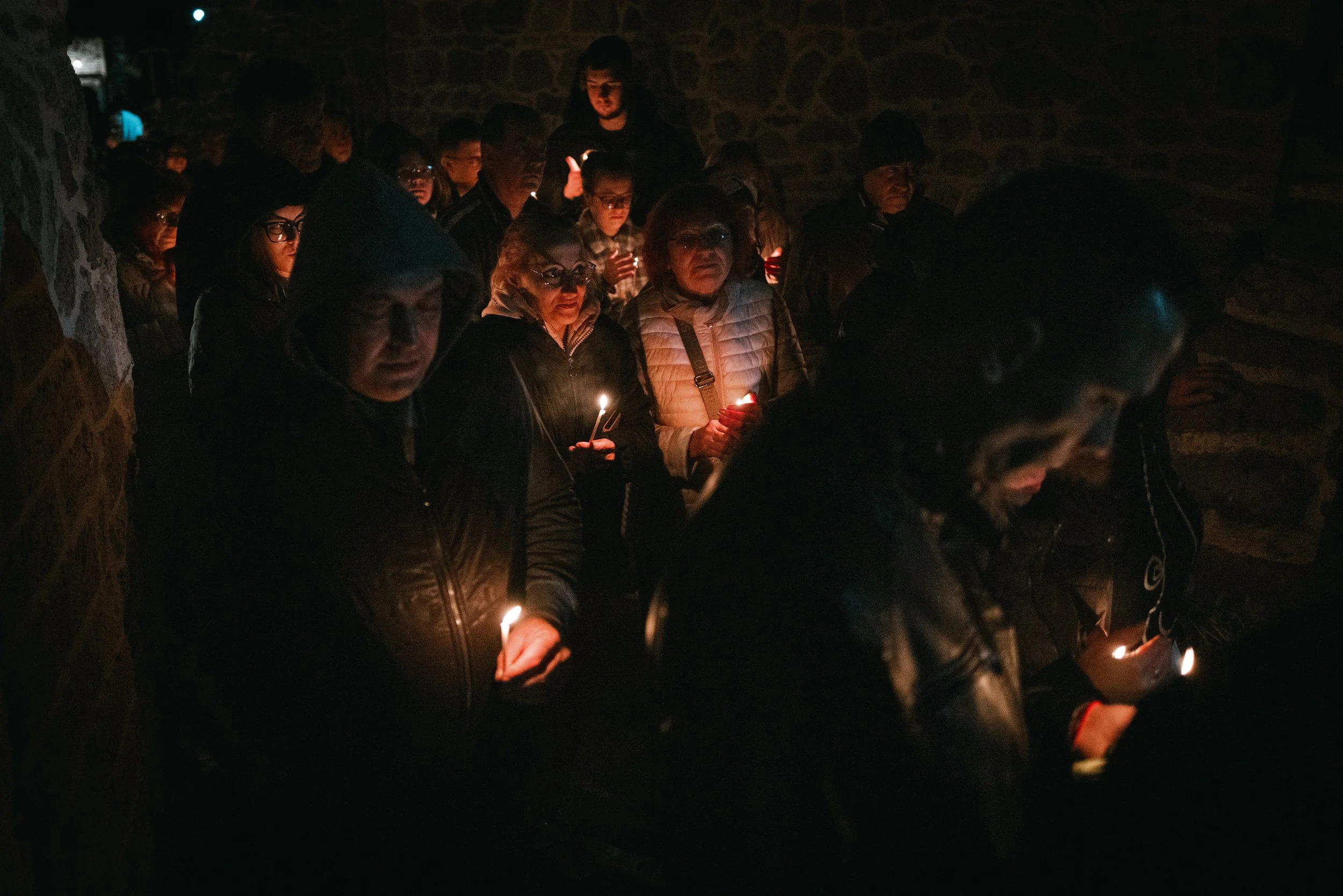 Worshippers walk in procession around the church after lighting their candles with the Holy Fire in Iskrets, Bulgaria on April 12, 2026. The scene is part of the Orthodox Easter service, symbolizing the Resurrection of Jesus Christ and the shared cel