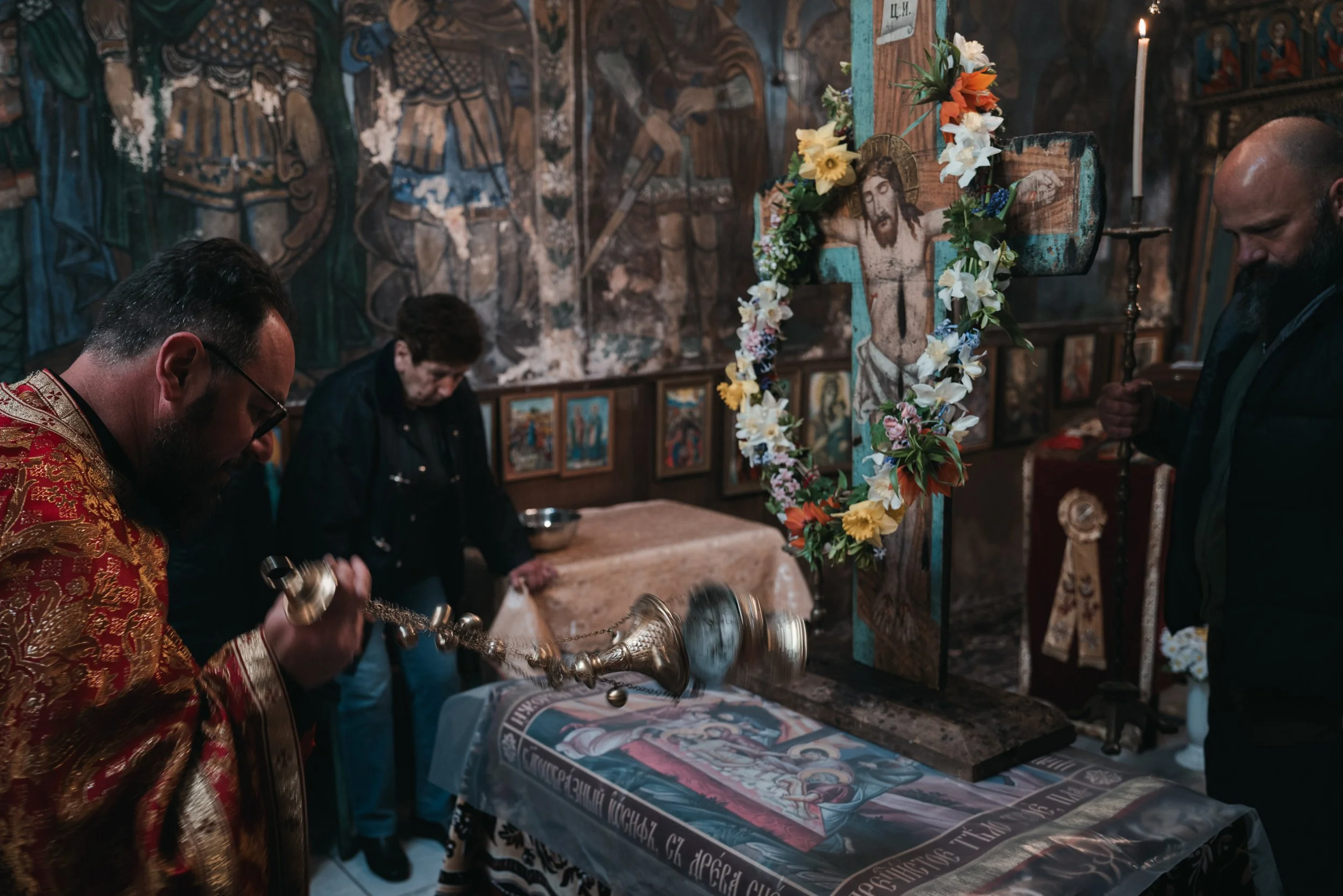 Archimandrite Januarij performs the ritual of censing before an image of Jesus Christ crucified placed on the Holy Shroud during the morning liturgy in the church in Iskrets, Bulgaria on April 10, 2026. The act of swinging the censer symbolizes praye