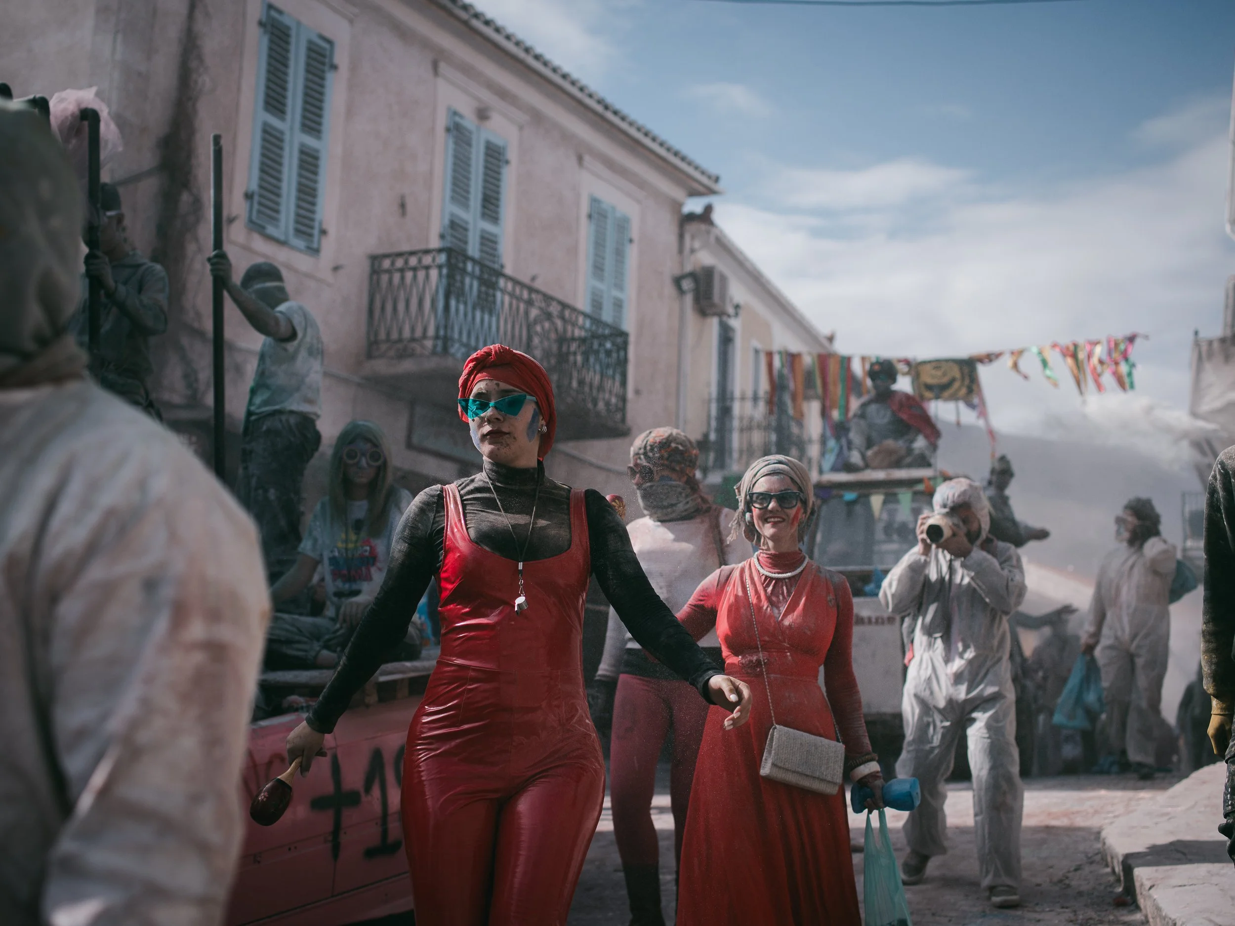 Two women dance during the historical tradition of “Alevromoutzouroma” (flour war) goes back in centuries, probably from the Byzantine period, during where the clowns-riders at horse races were engaged in a cheerful spirit, painting their faces.
