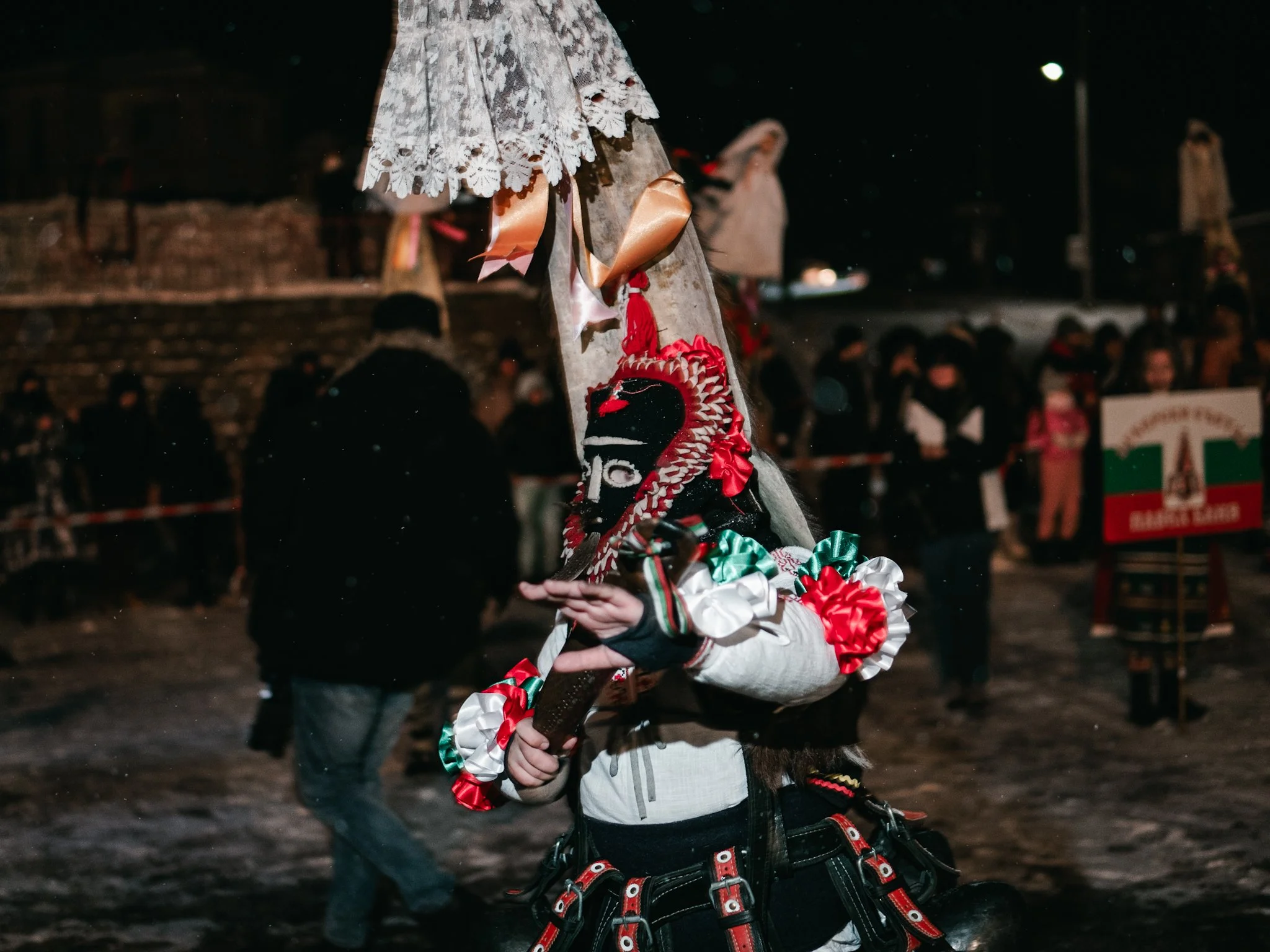 A Kuker, wearing a traditional mask and wielding a sword, performs an energetic dance as part of the Surva celebrations in Kosharevo, preserving ancient rituals meant to drive away evil spirits.