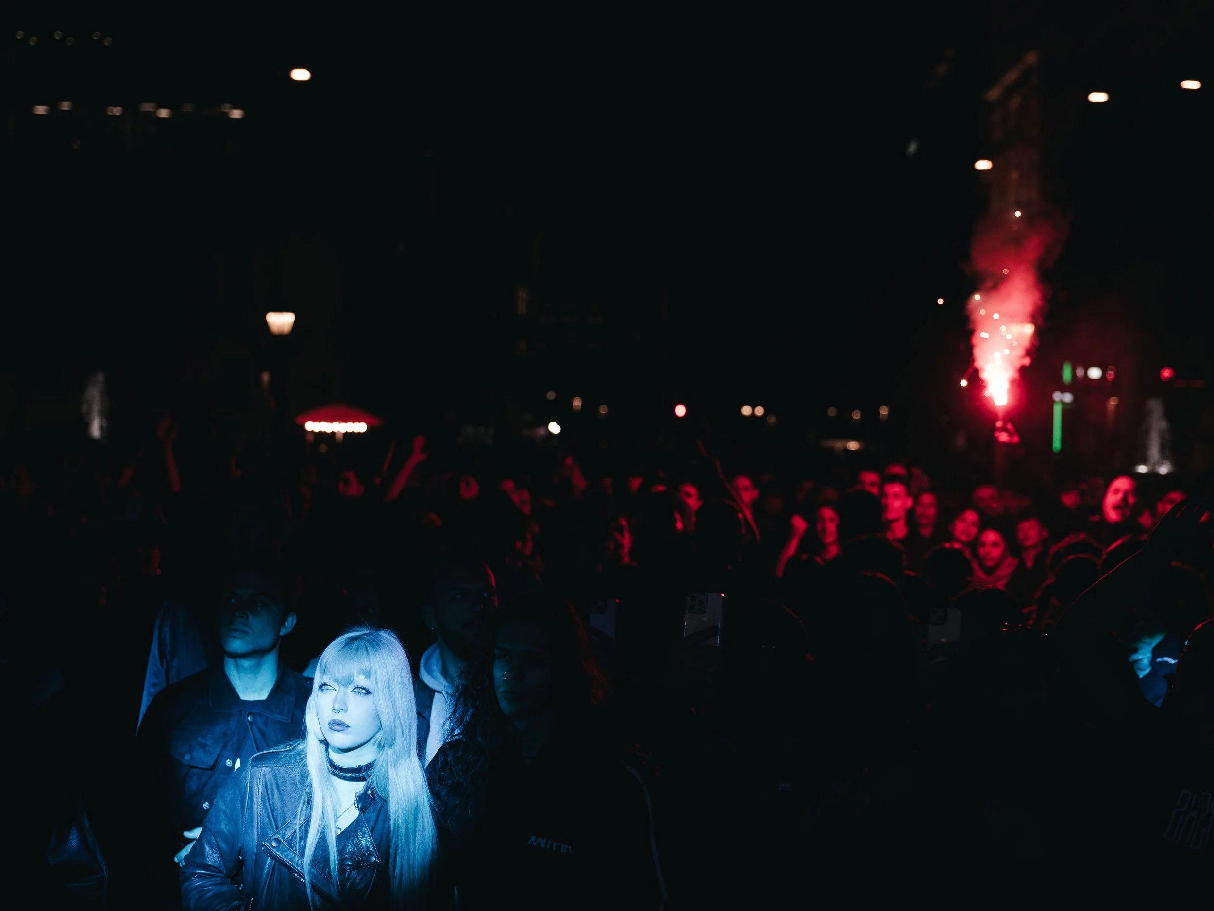 A girl stands in front of a stage illuminated by lights during a concert in Athens, Greece on April 5, 2025. The event was organized by student unions in solidarity with the families of the victims of the Tempi tragedy.