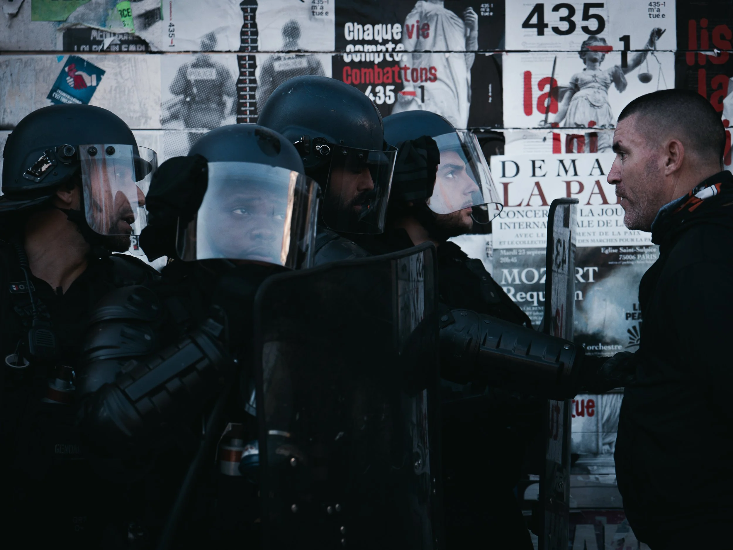 A man confronts police officers and speaks to them during clashes during the national strike in Paris, France on September 18, 2025.