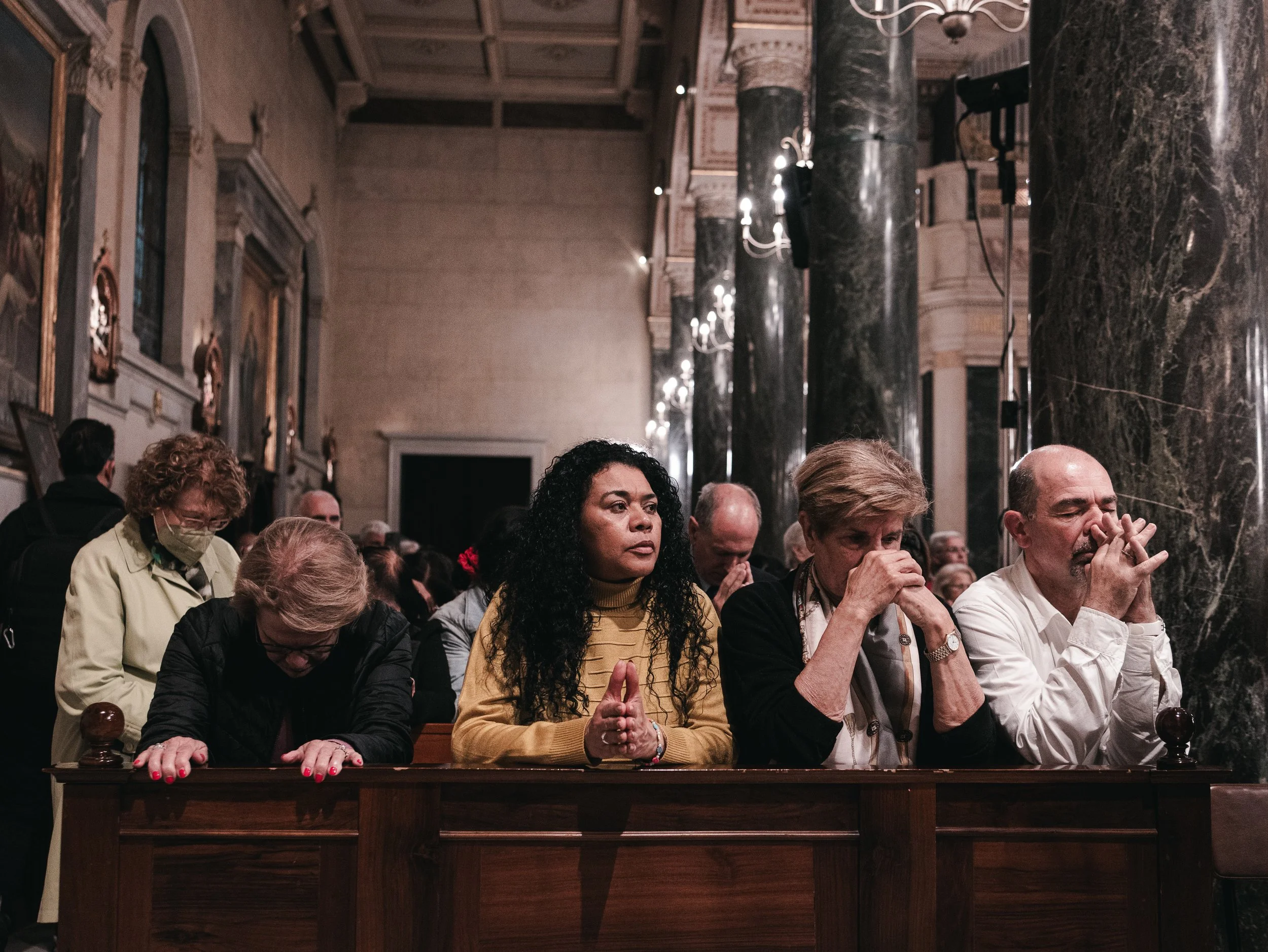 Worshippers pray during a memorial service for Pope Francis III at the Basilica of Saint Dionysius the Areopagite in Athens, Greece, April 25, 2025.