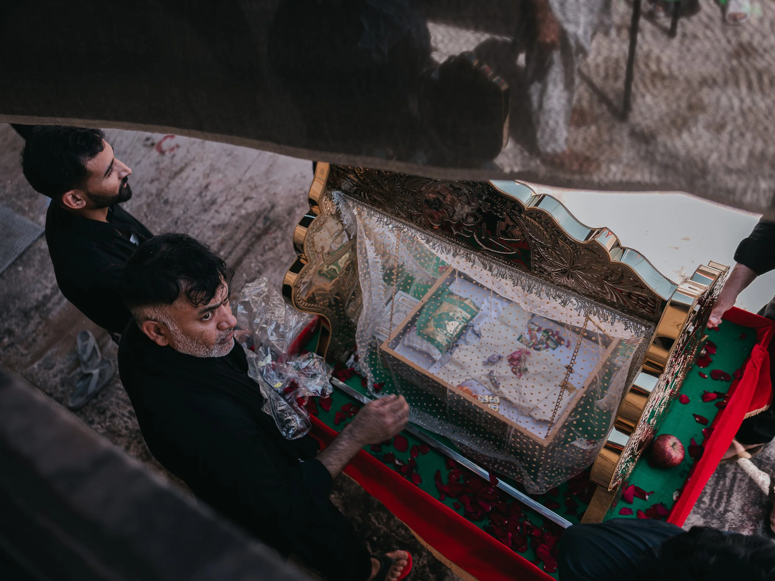Men prepare a symbolic child’s coffin beside the self-organized Shi’a mosque in Peristeri, Athens, Greece on July 6, 2025. The coffin represents the martyrdom of Ali Asghar, the infant son of Imam Husayn, and is part of the Ashura commemorations hono