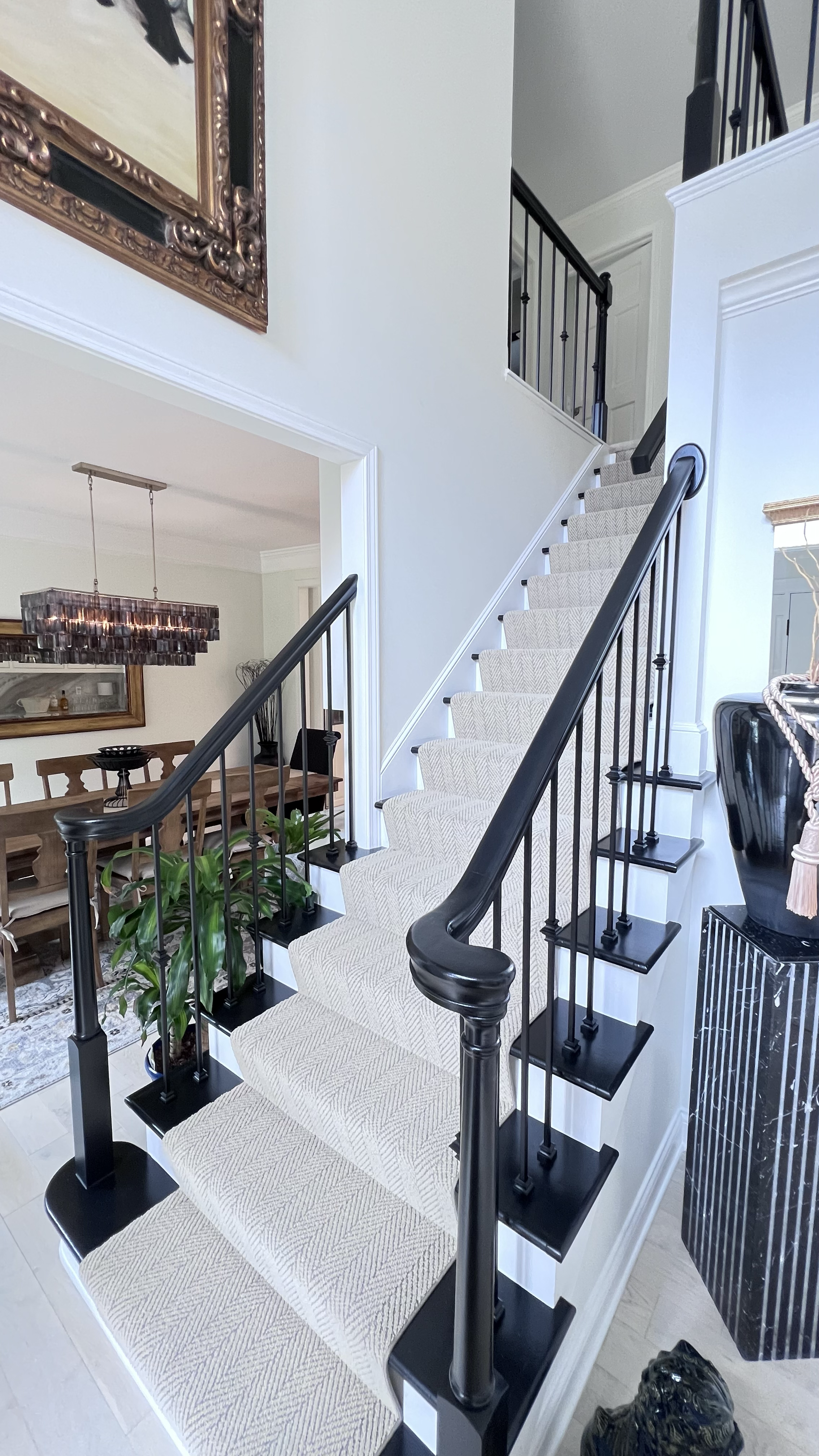 Custom-built staircase with curved handrails divides kitchen and dining room renovations.