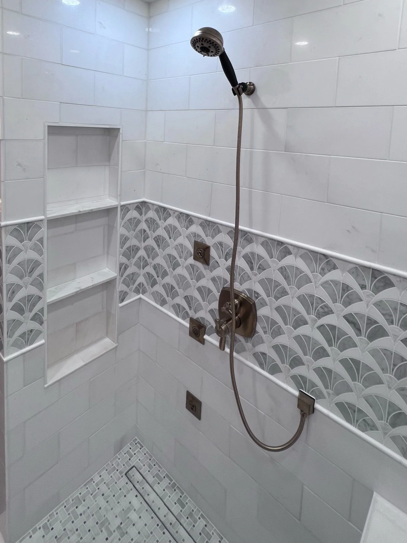 Bathroom shower renovation with custom tile work and shower wand.