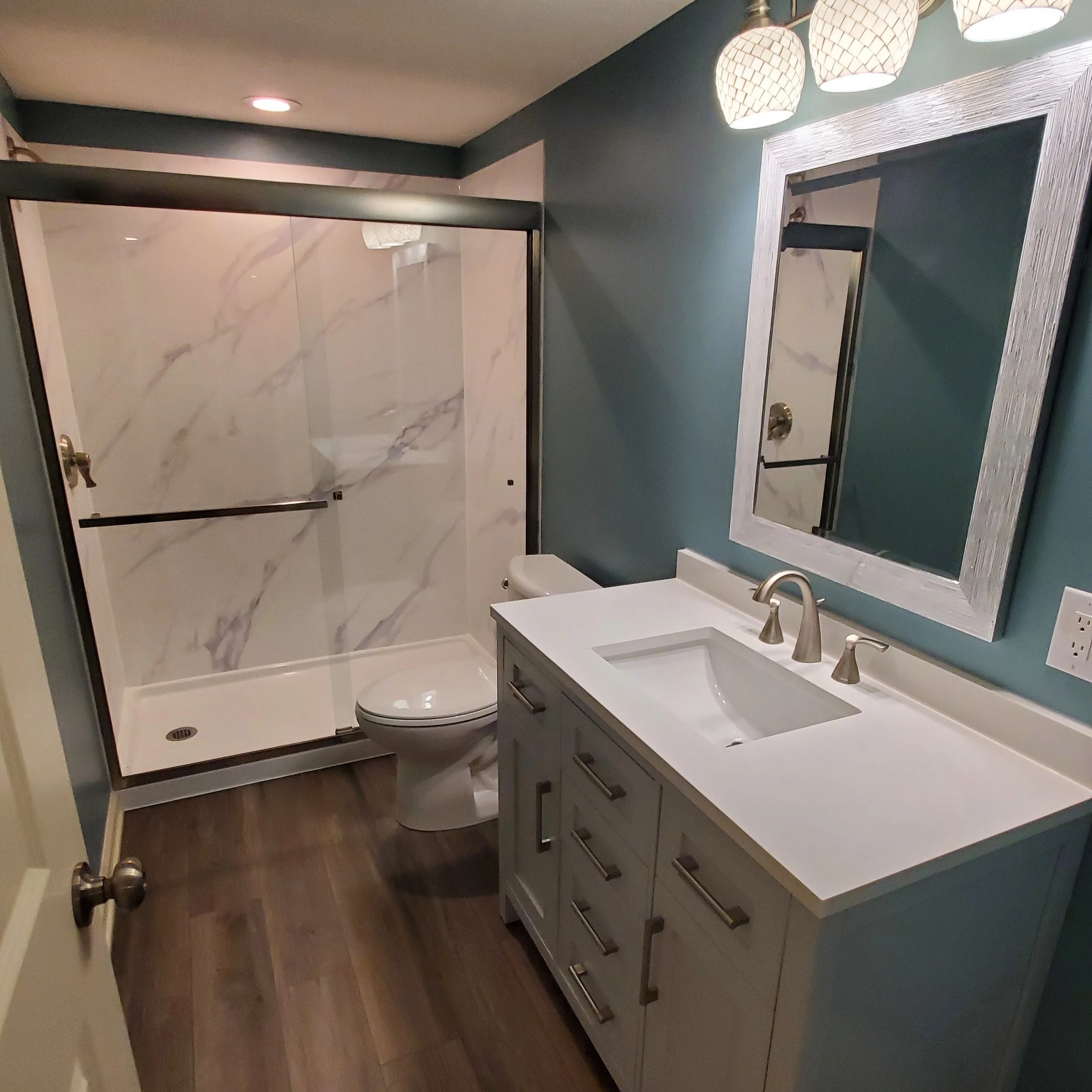 Bathroom remodel with marble slab shower walls and new vanity.