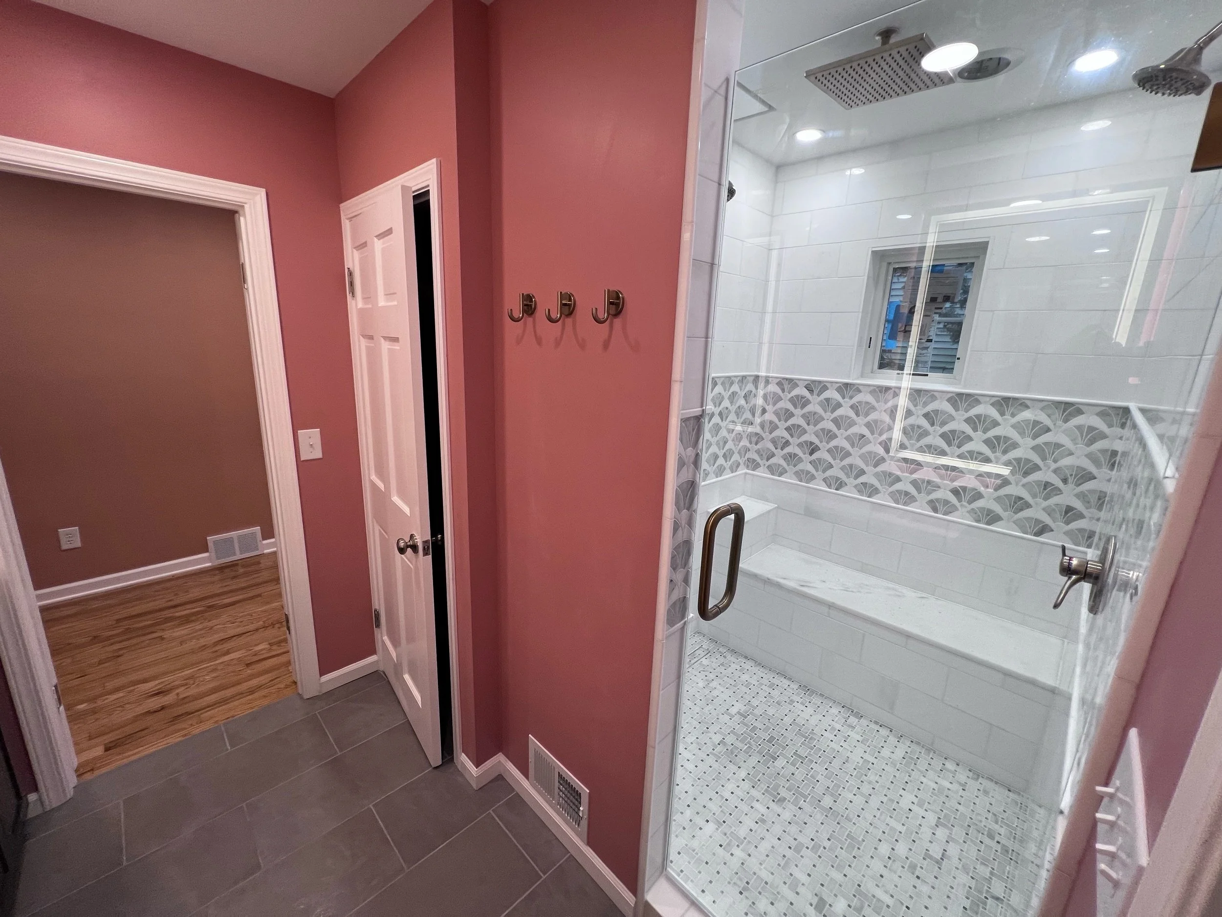 Bathroom renovation showing walk in shower with custom tile.