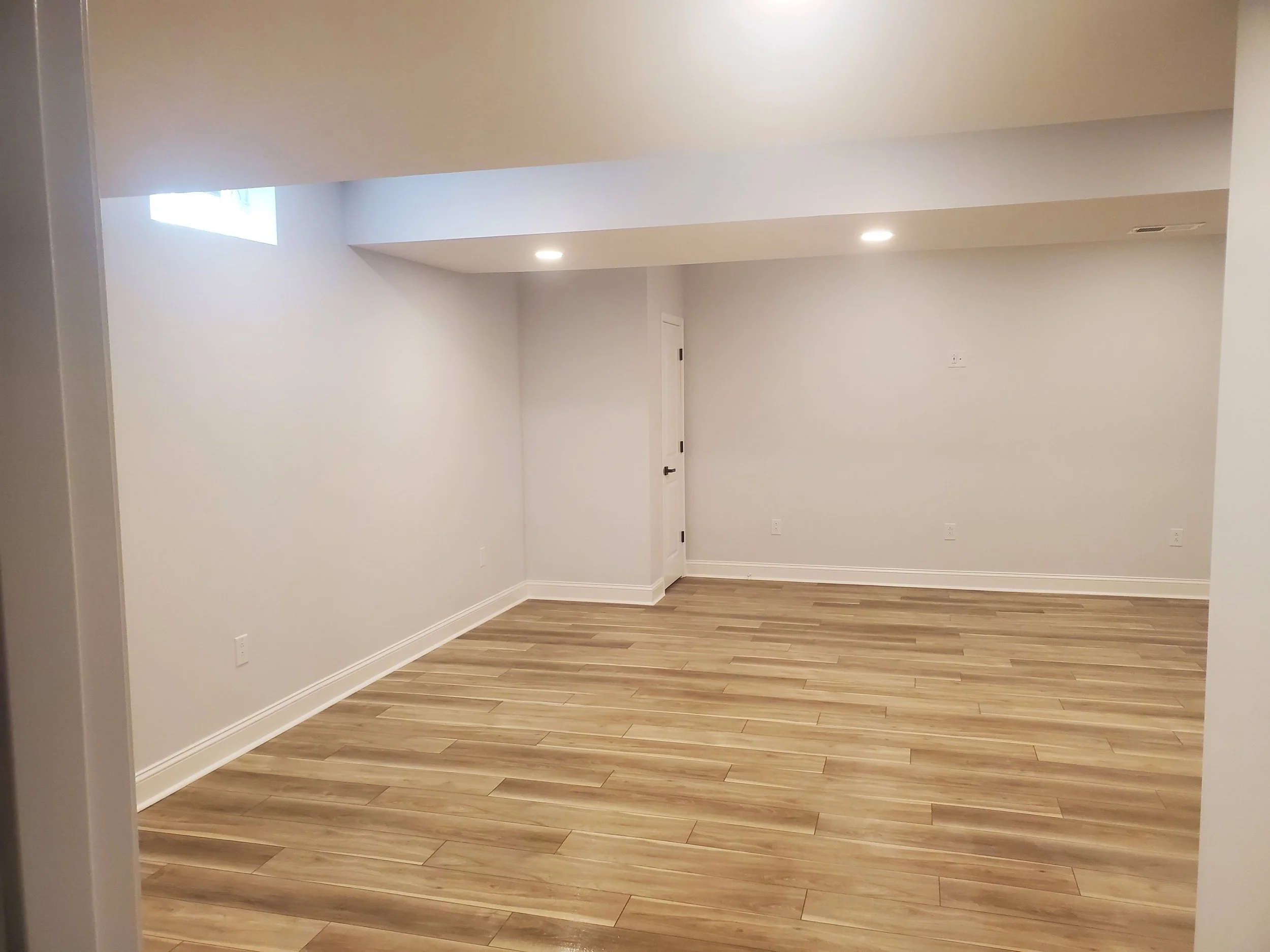 Basement remodel with custom hardwood flooring.