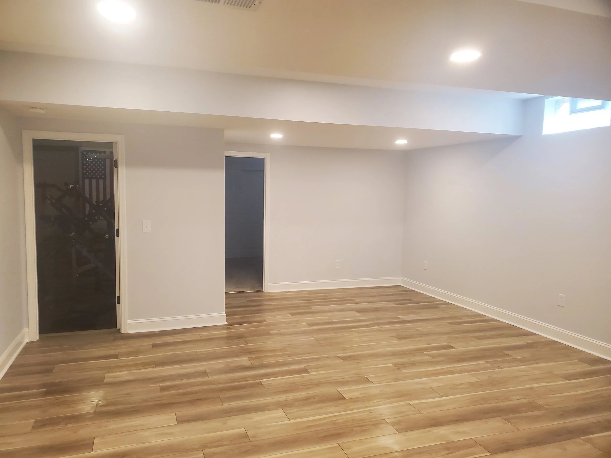 Basement remodel with new basement flooring and overhead lighting