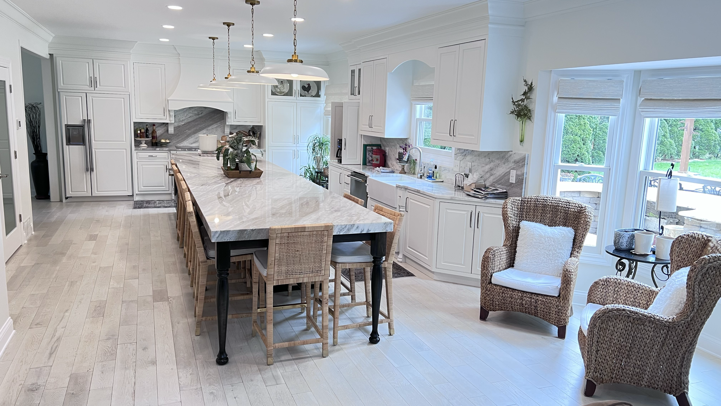 Kitchen remodel with long marble slab island dining counter, seating for eight.