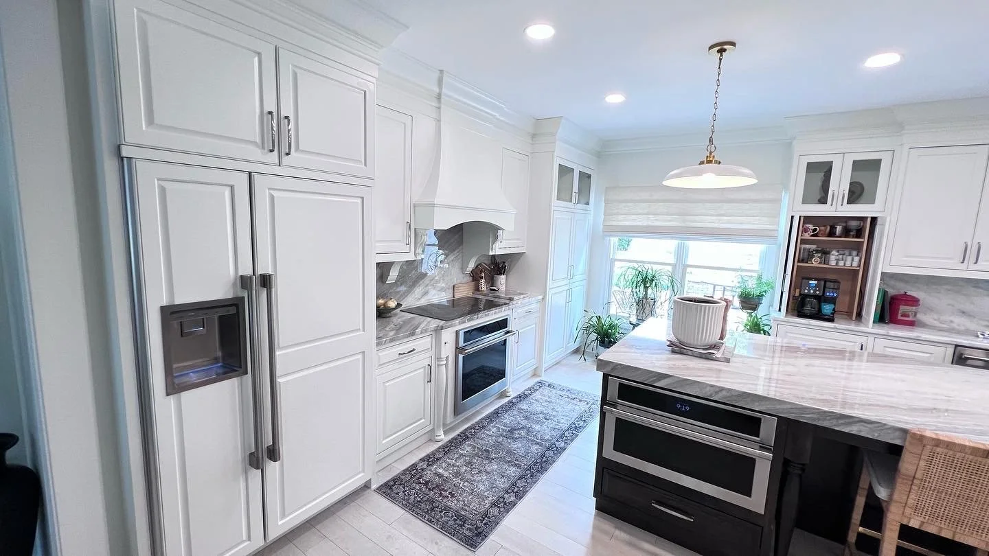 Kitchen renovation with custom cabinets, custom tile backsplash and marble slab island.