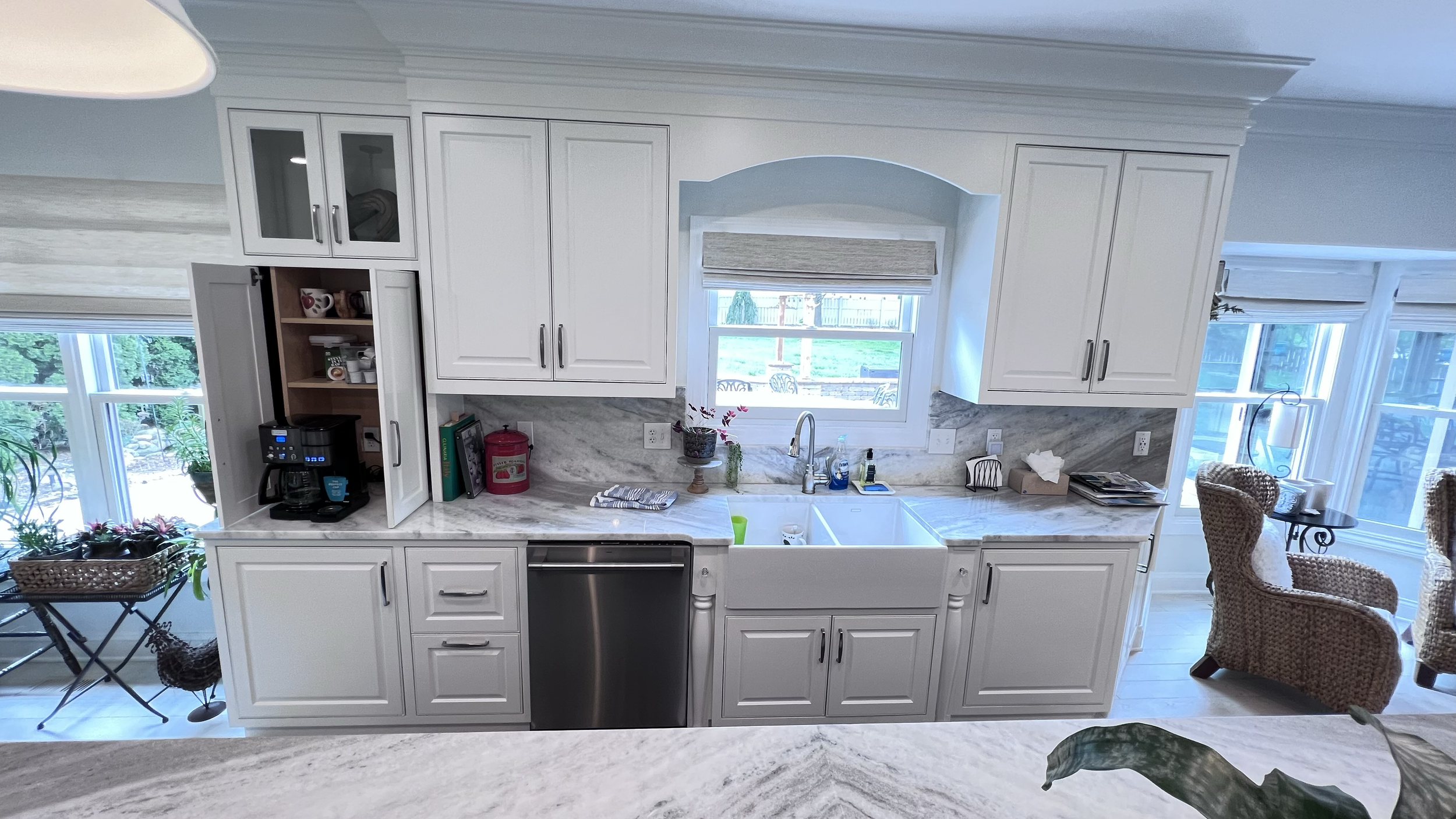 Kitchen renovation with custom cabinets, hideaway coffee cabinet and farm sink.