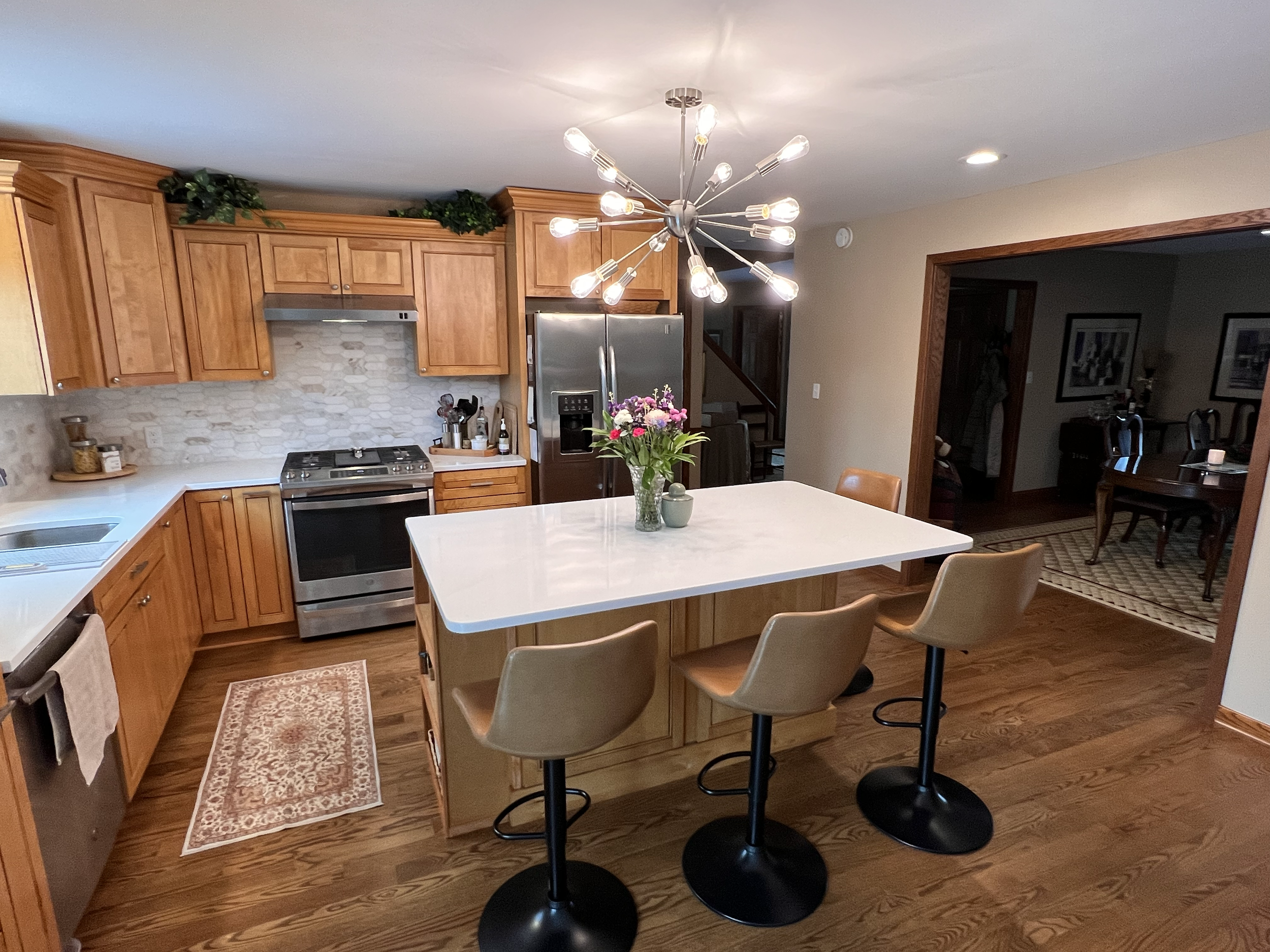 Kitchen renovation with formica island and countertops, cherry wood cabinets and upgraded lighting.