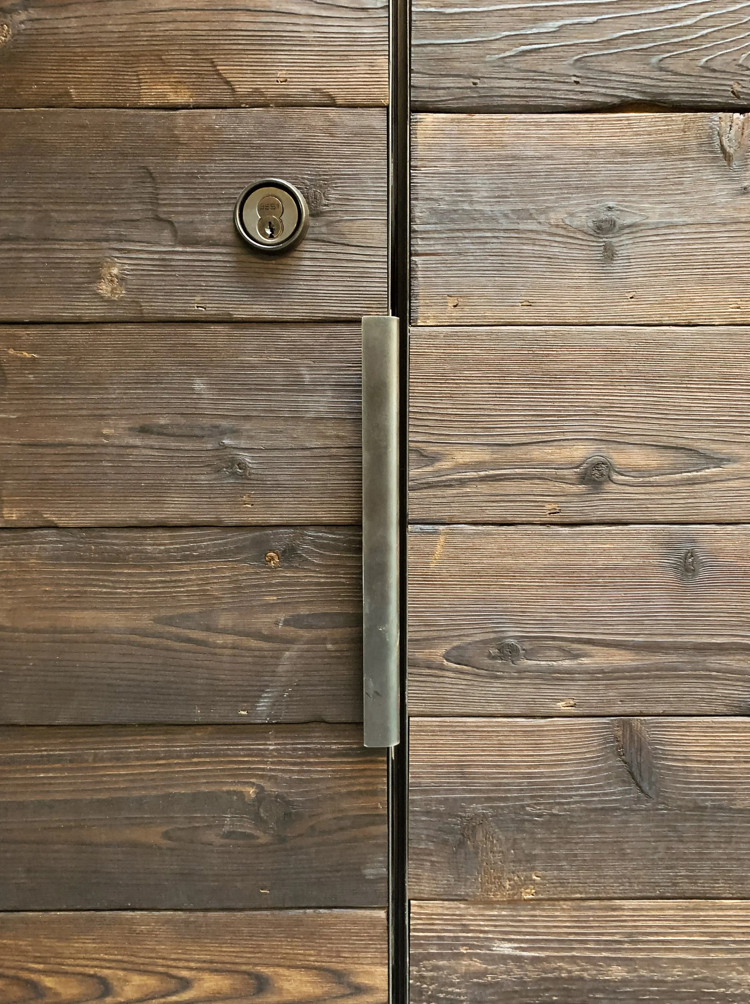 Detail of a custom wooden interior door and modern architectural trim.
