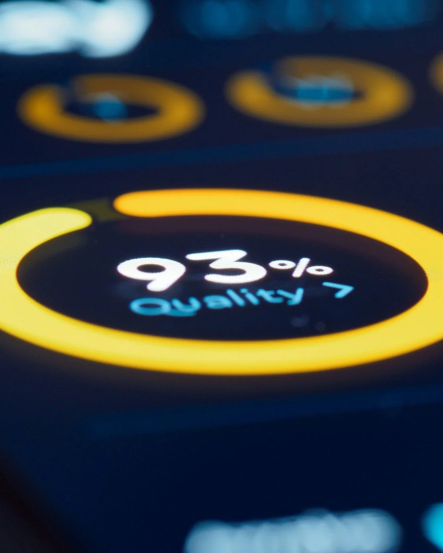Close-up of a smartwatch screen displaying 93% battery remaining, with blurred app icons in the background.