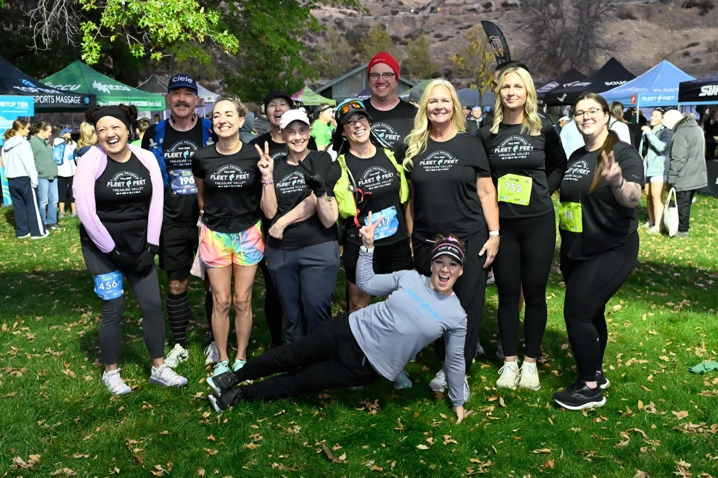 A run club group in matching shirts with their race bibs at Idaho Running Day
