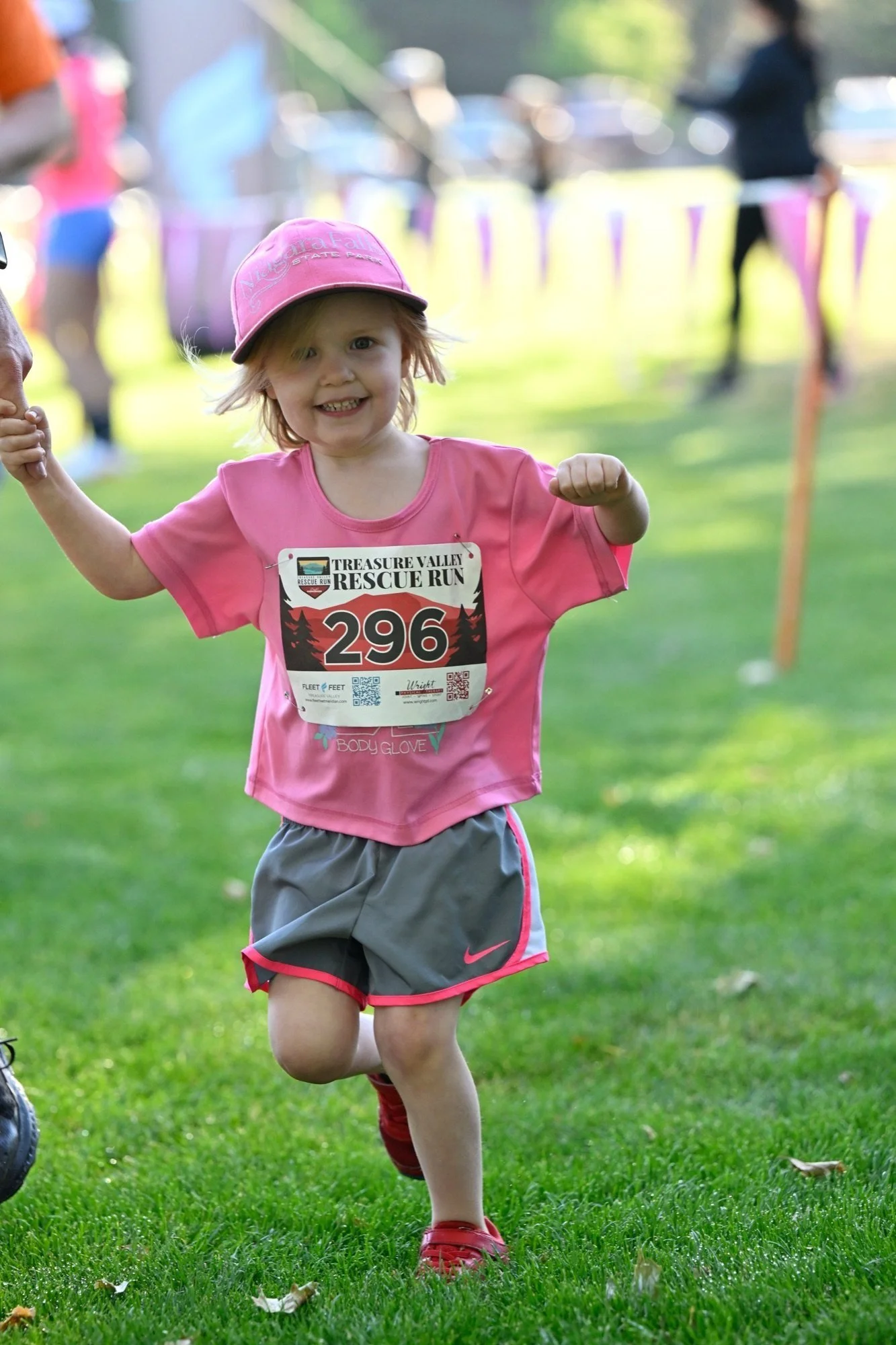A young runner in pink races the kids dash at the Treasure Valley Rescue Run