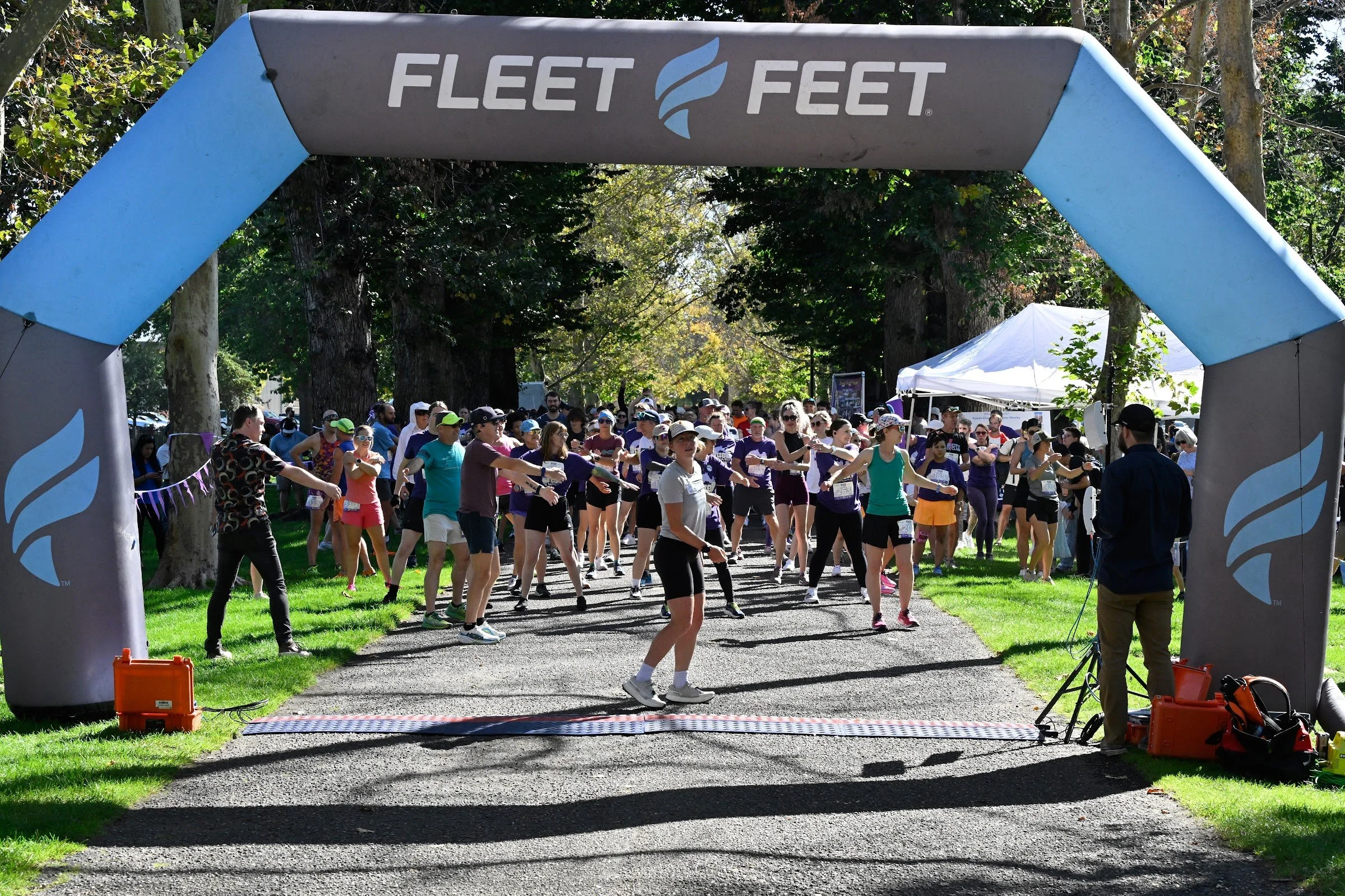SueB walkers and runners gathered under the Fleet Feet arch in Julia Davis Park