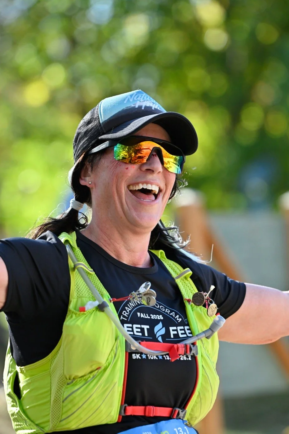 A smiling runner celebrating at the Idaho Running Day finish