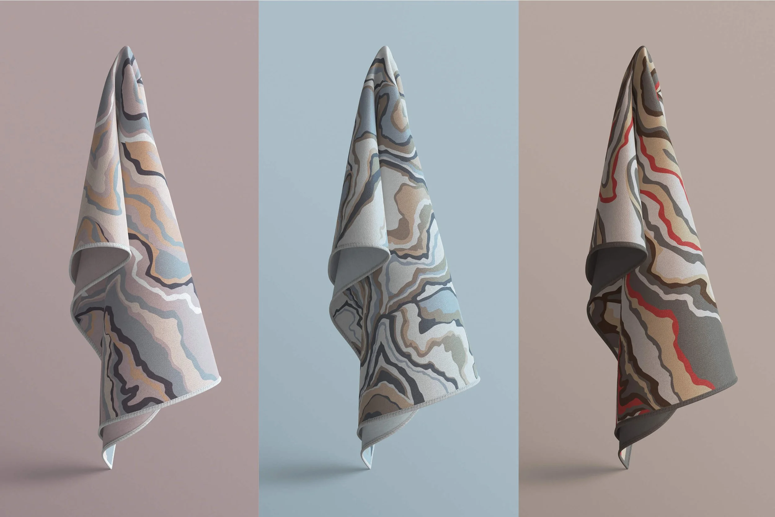 Three abstract-patterned hanging towels with different background colors: pink, blue, and gray.
