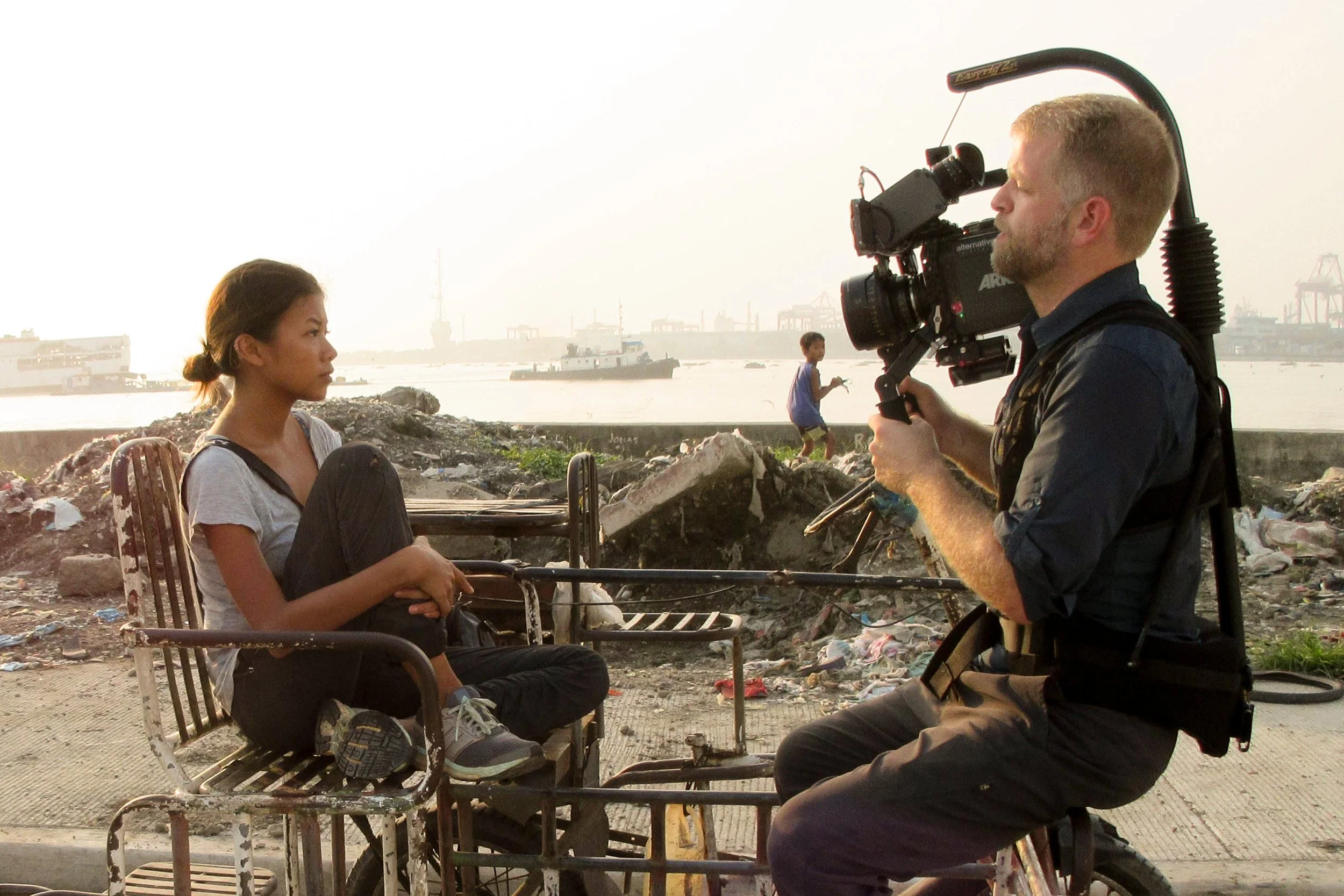 Cinematographer filming a documentary style brand story interview on location