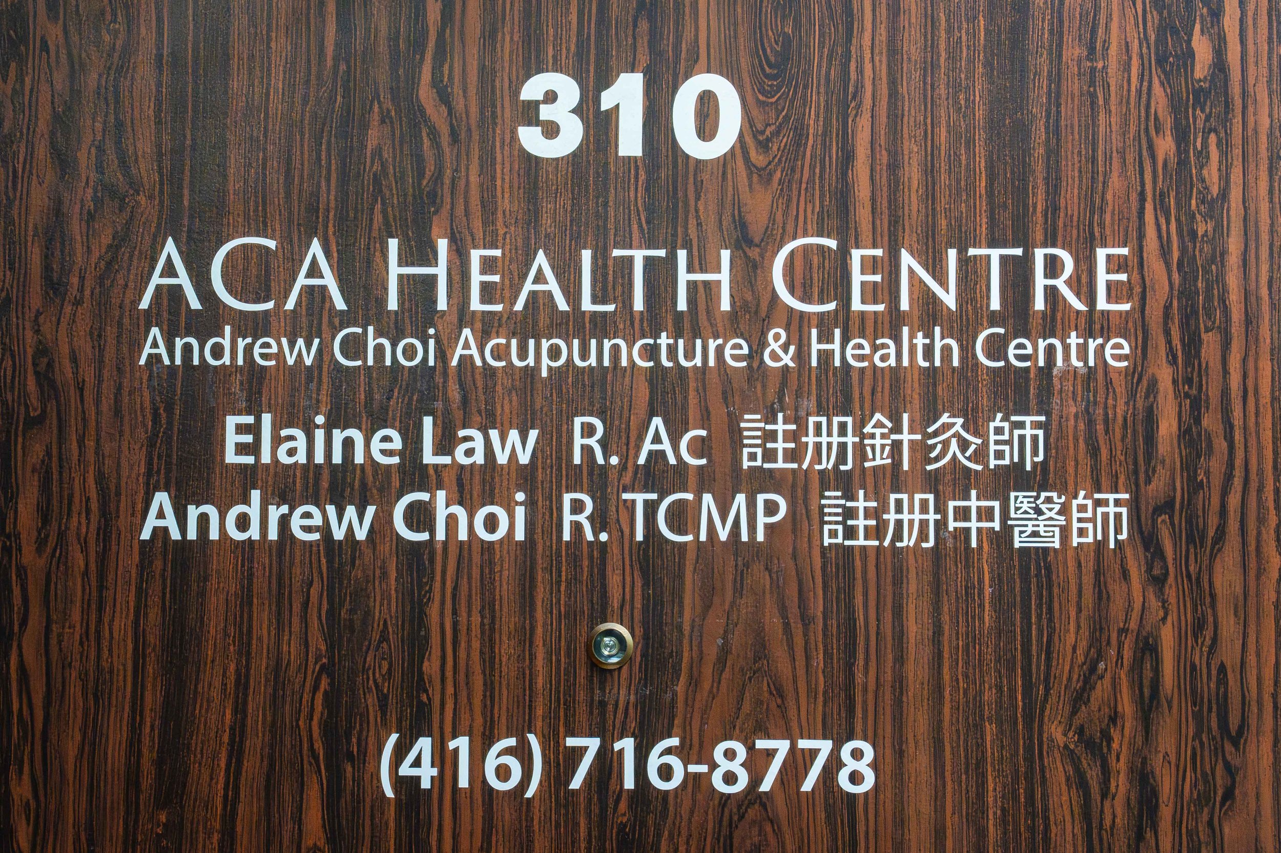 Sign for ACA Health Centre with acupuncture services, displaying the names Elaine Law and Andrew Choi, along with a contact phone number.