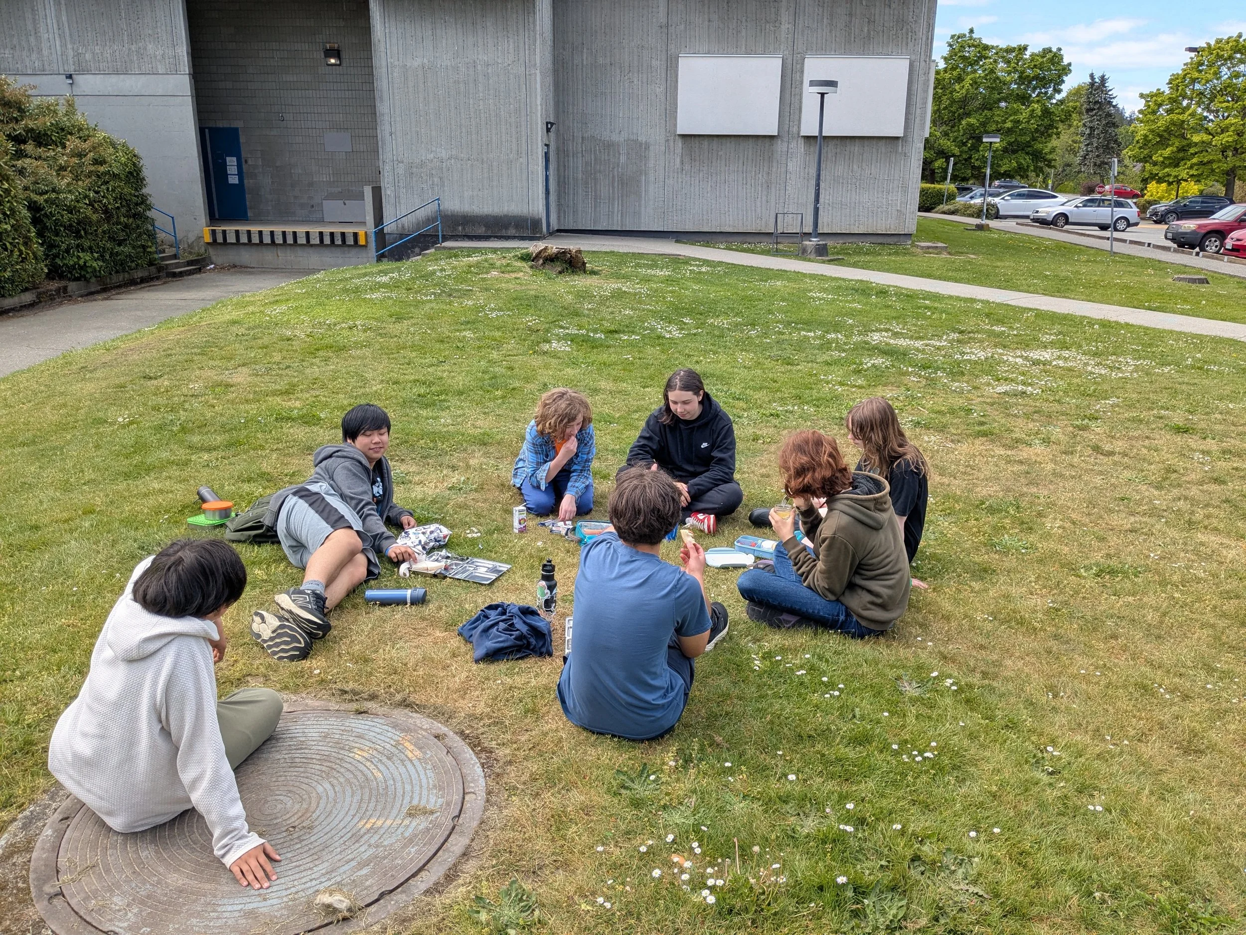 Students sitting in the grass