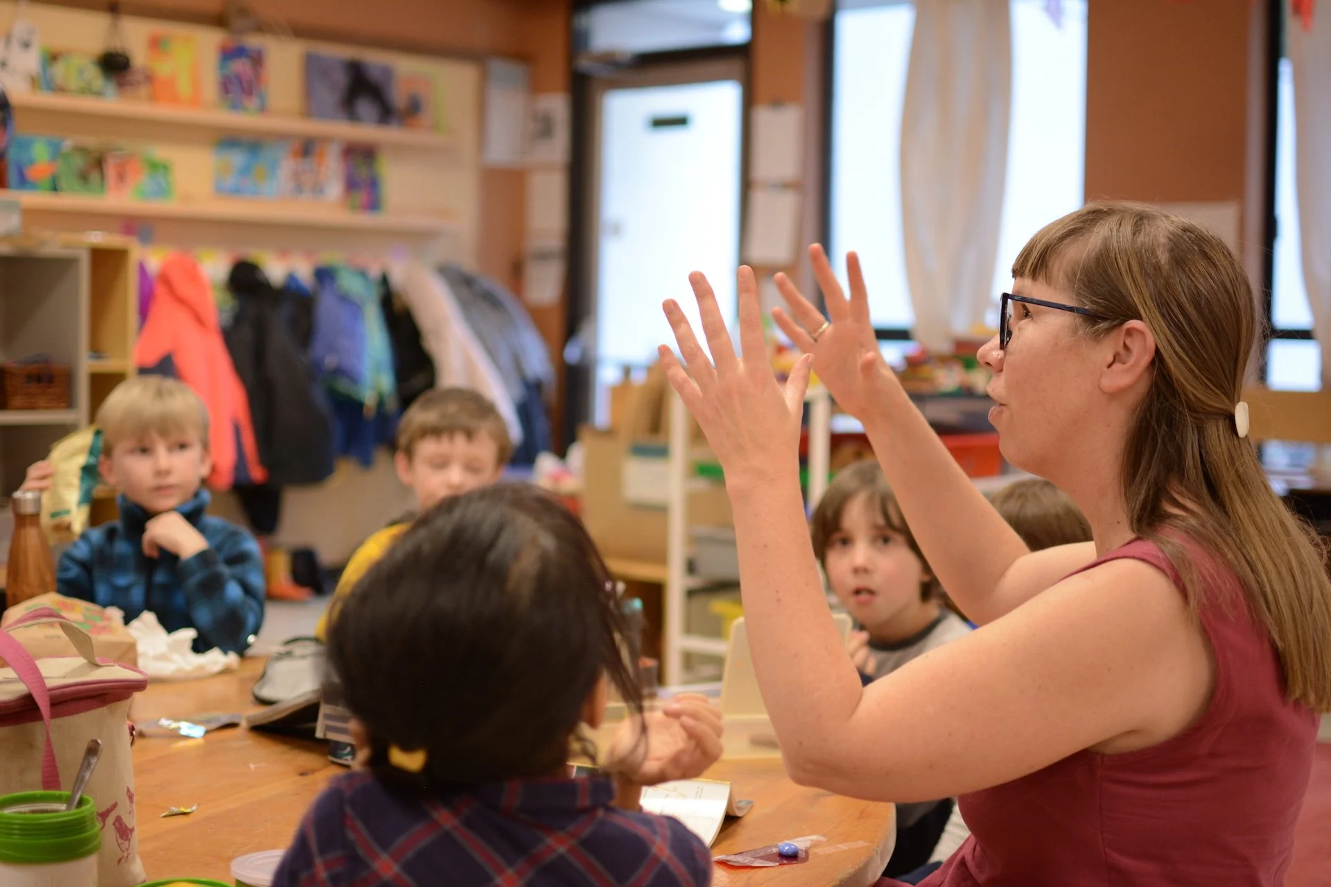 A teacher and student having a discussion around a table