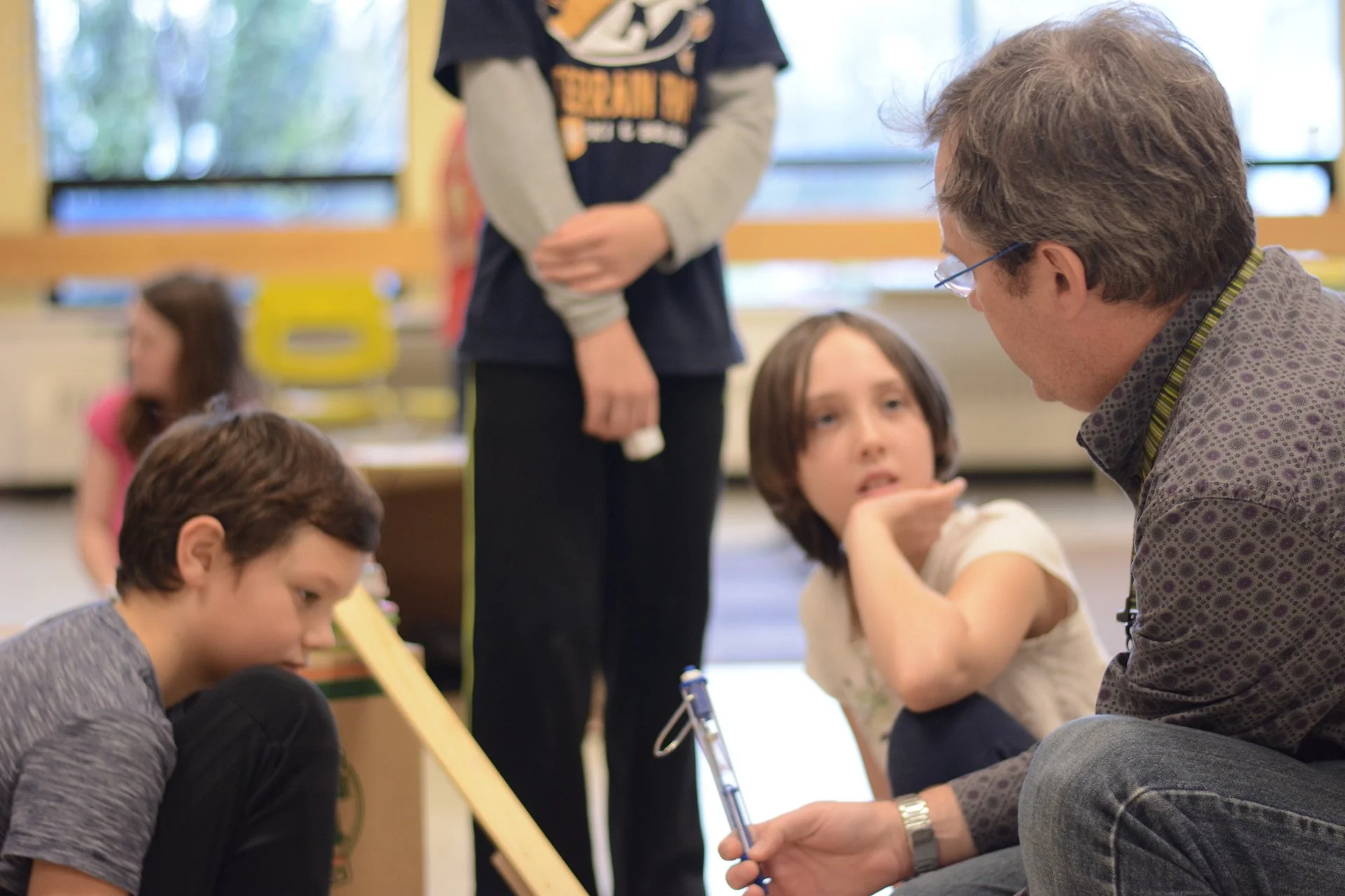 A teacher speaking with two students
