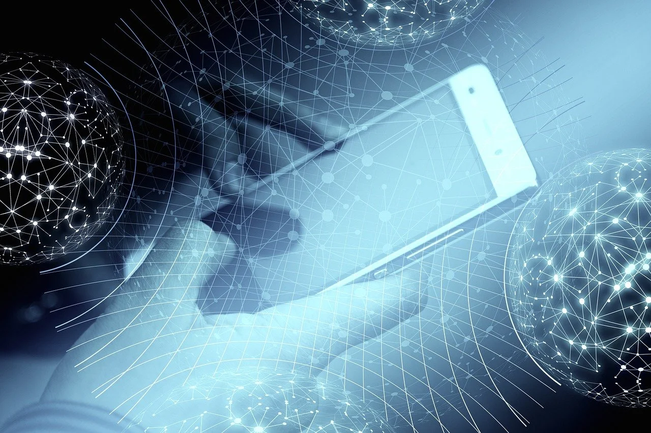 A person holding a smartphone surrounded by digital network graphics and glowing wireframe globes.