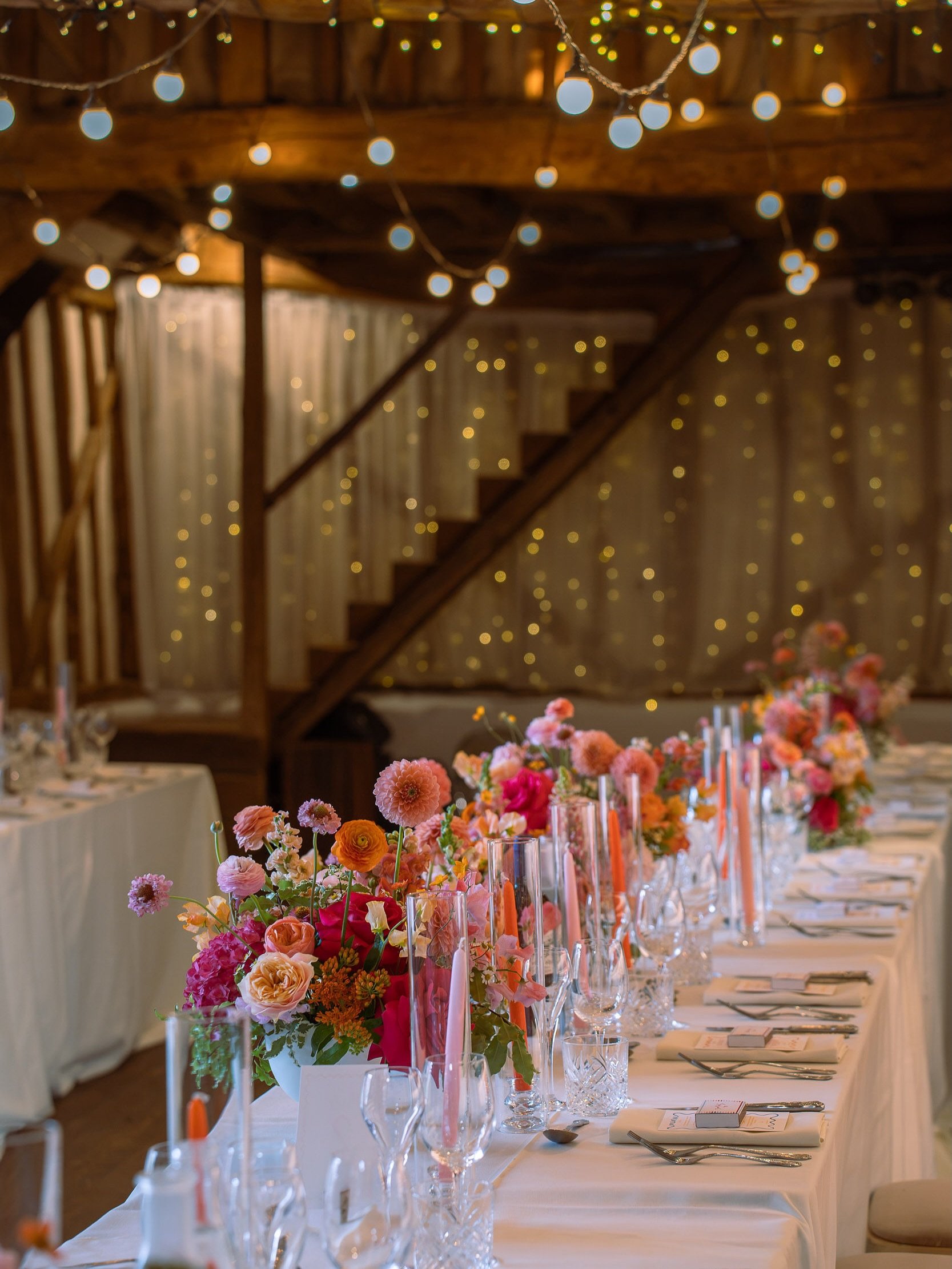 If sunsets could become wedding flowers&hellip; this would be them 🌅

Tangerine, fuchsia, peaches and pinks came together in a sun-kissed palette beneath a canopy of twinkling lights ✨

There&rsquo;s something so magical about a room that feels warm