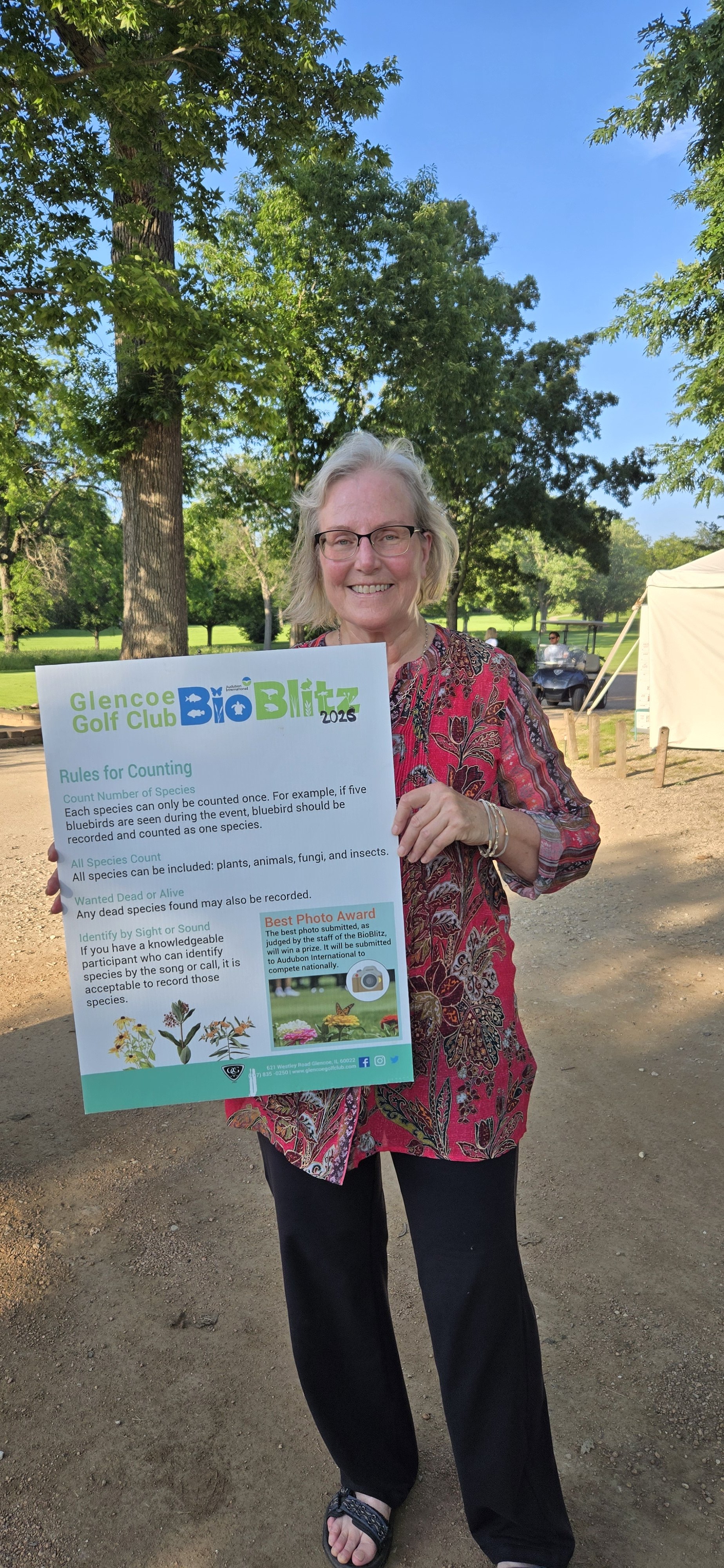 Participation Award 1st Place: Glencoe Golf Club's Participant Holding a BioBlitz Sign