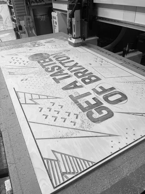 A sign with the text "G.O. GRESHER UNION BRIDGE" on a worktable, with construction tools and equipment visible nearby.