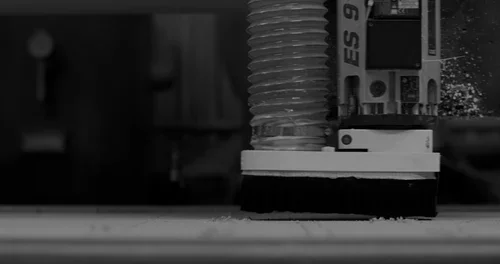 Close-up of a CNC machine cutting or milling a piece of material.