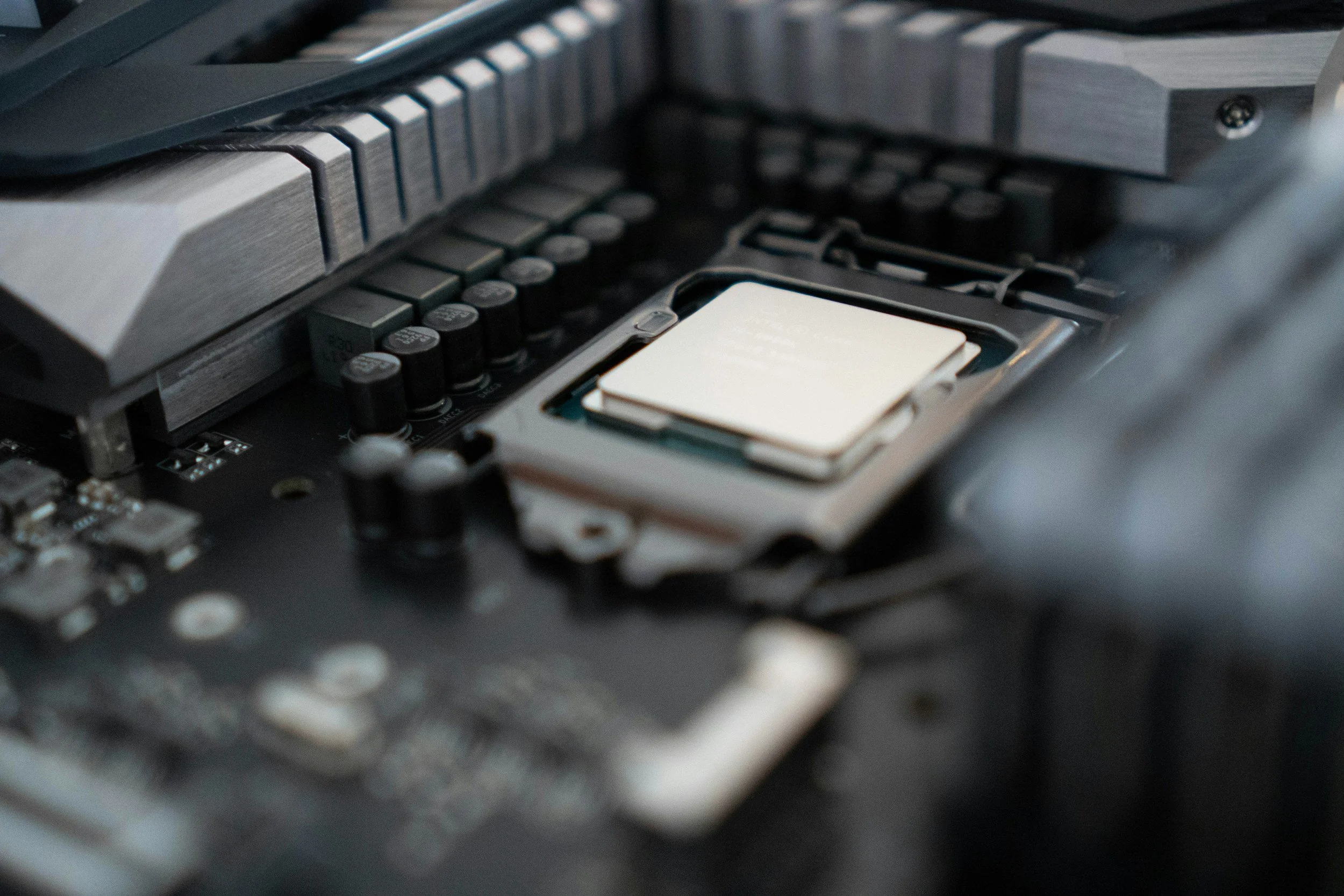 Close-up of a computer motherboard with a CPU socket and an empty CPU chip slot.