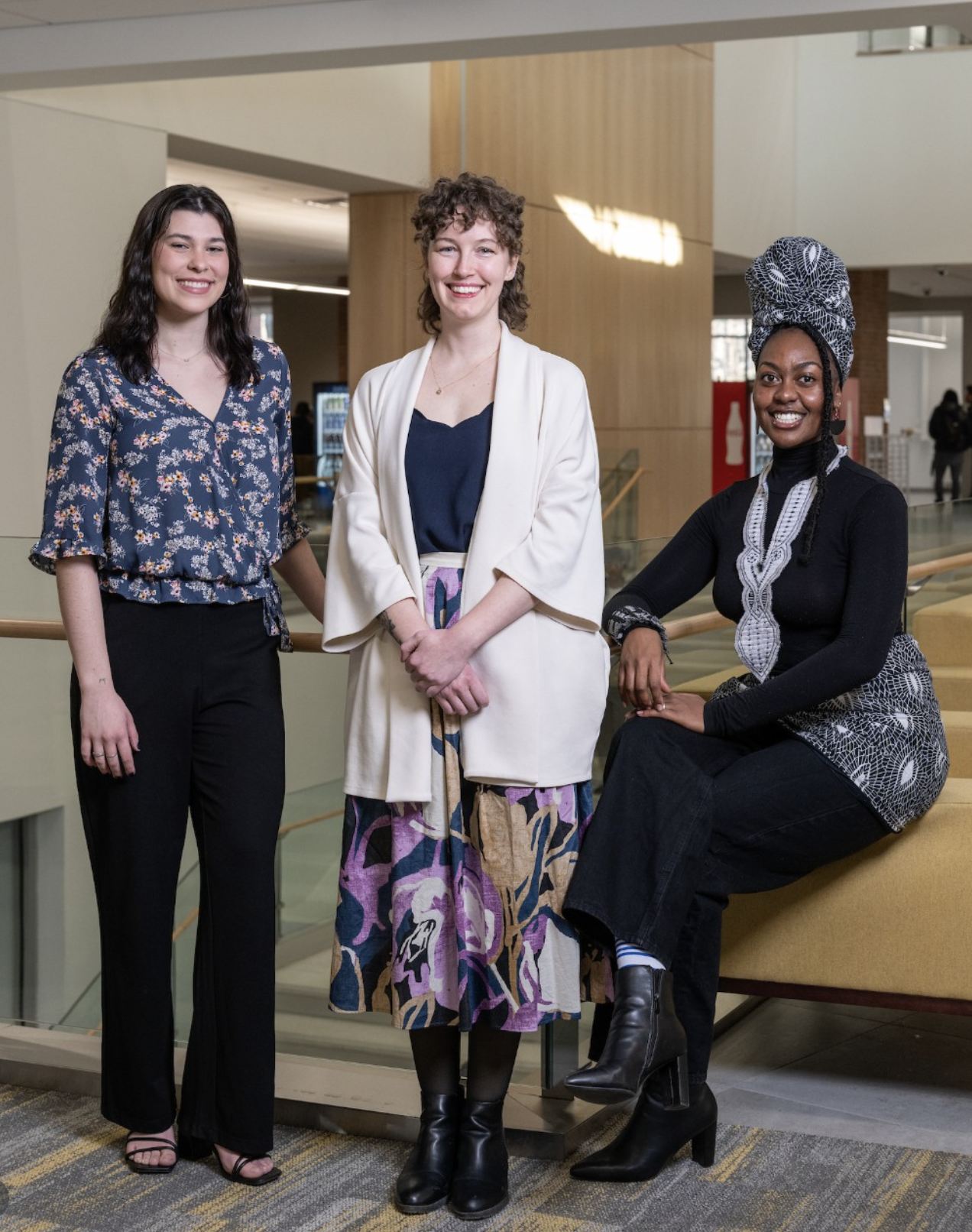 Visual artist Sierra DeVuyst, a Fulbright semi-finalist, standing with Myah Blackmon and Rose Marika Mwansa at Towson University.