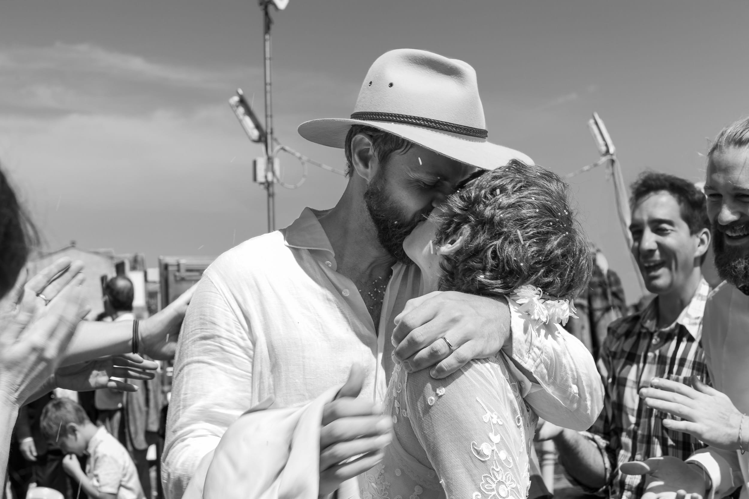Bride and Groom kiss under rice thrown in Venice, Italy.
