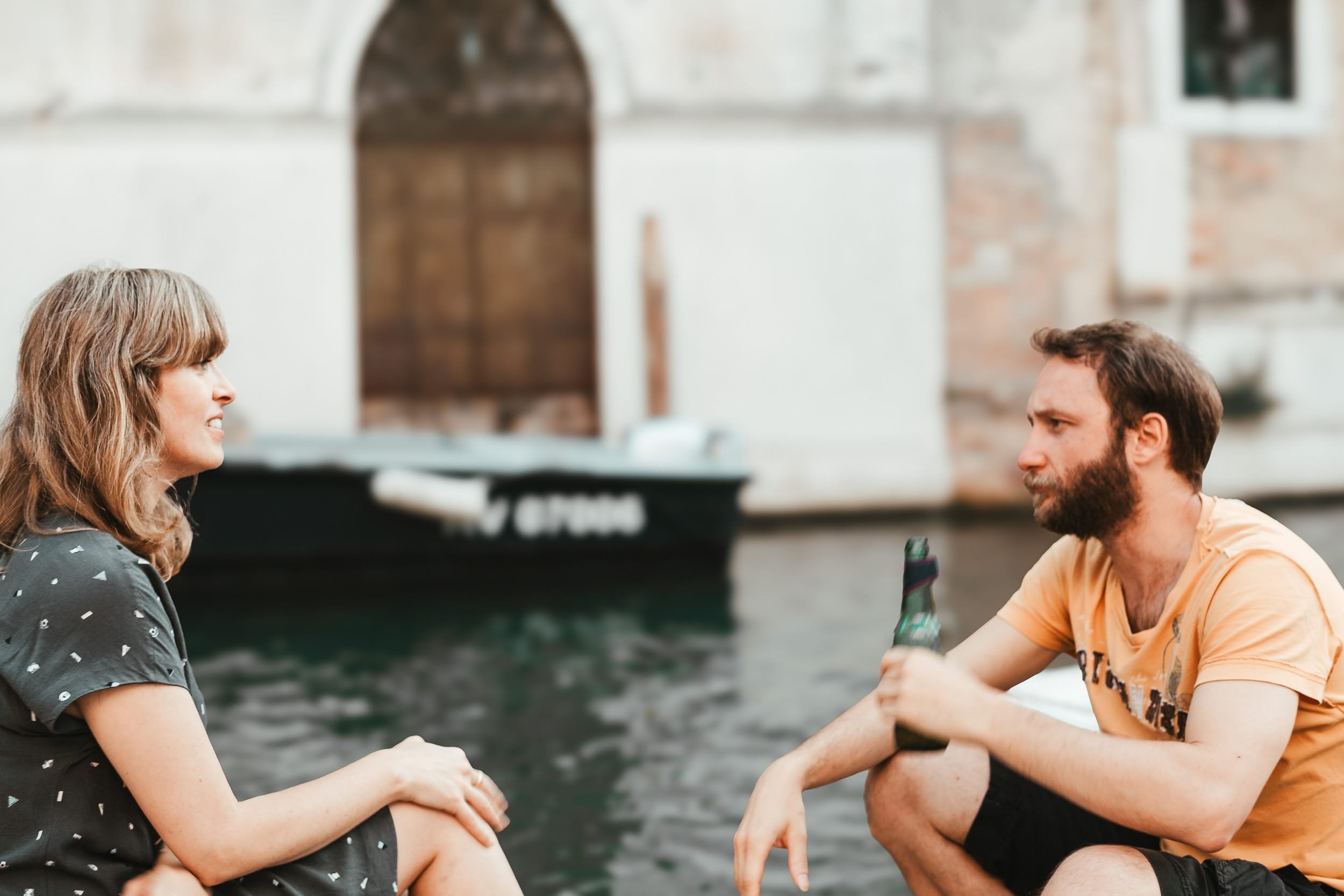 Wedding guests cooling off with a chill beer by the Venice canal.