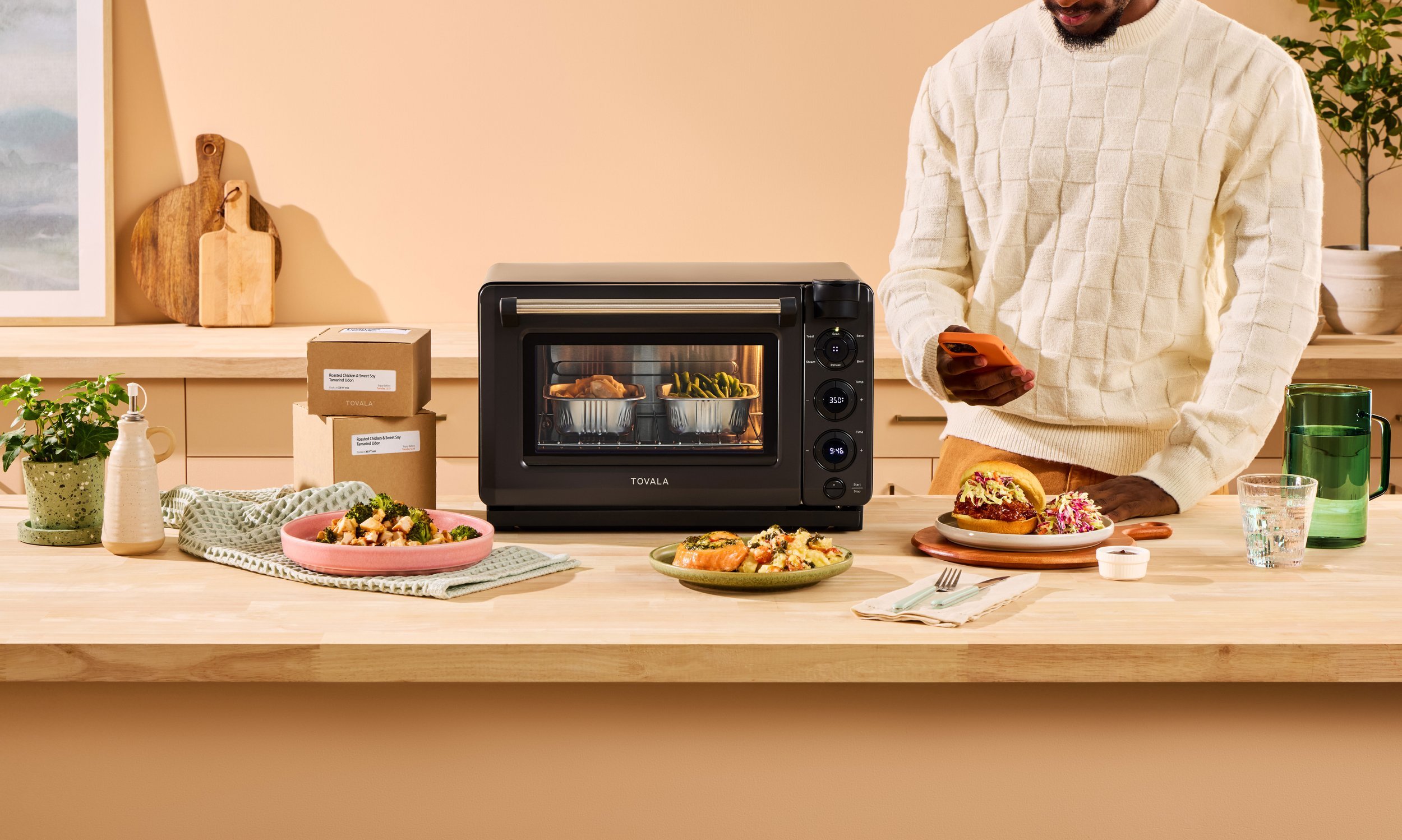 Tovola compact countertop oven displayed in a warm lifestyle setting, showcasing kitchen appliance product photography