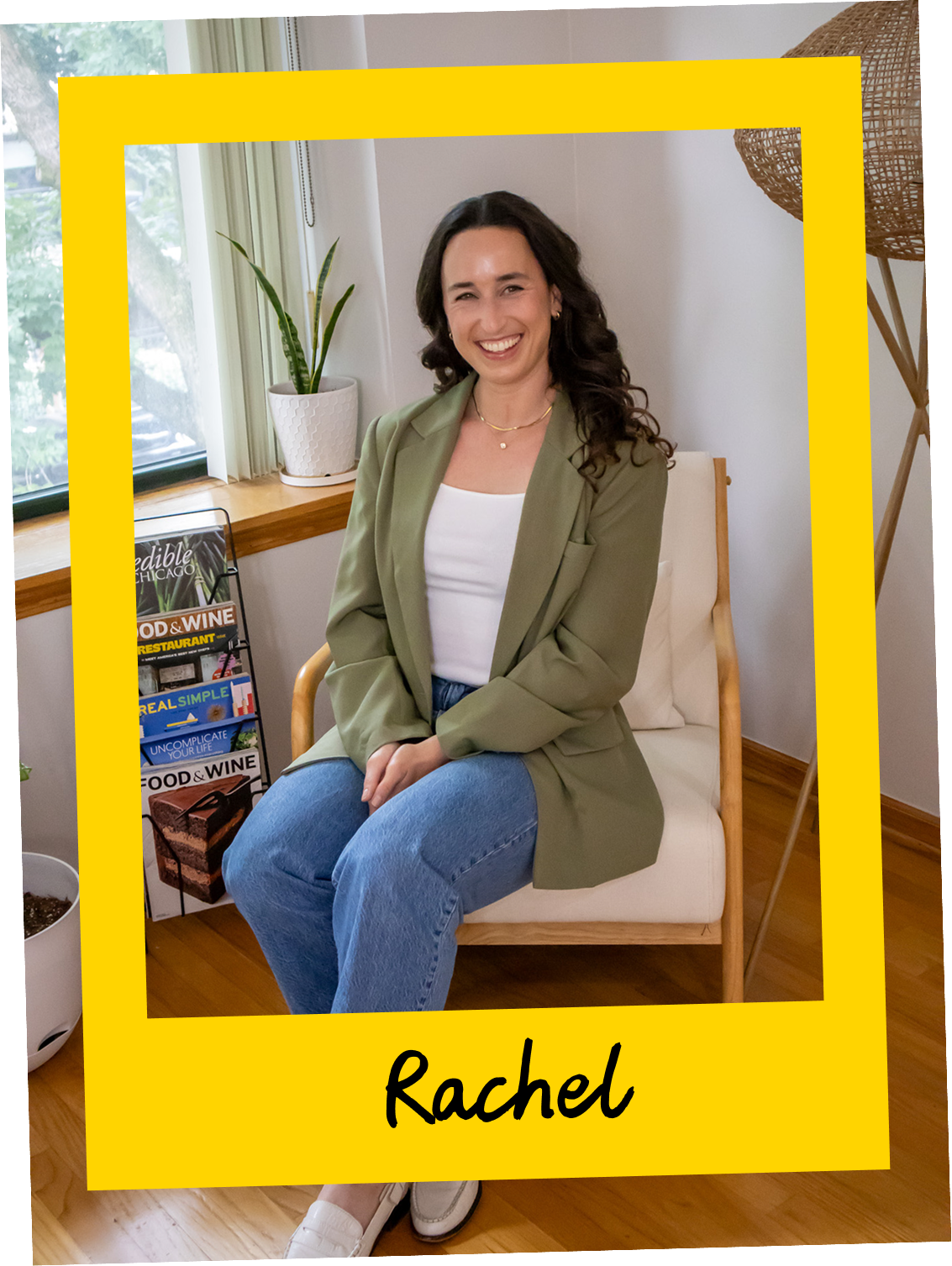 Rachel, founder of Kitchen Sink Communications, seated casually in a bright interior wearing a green top, smiling warmly