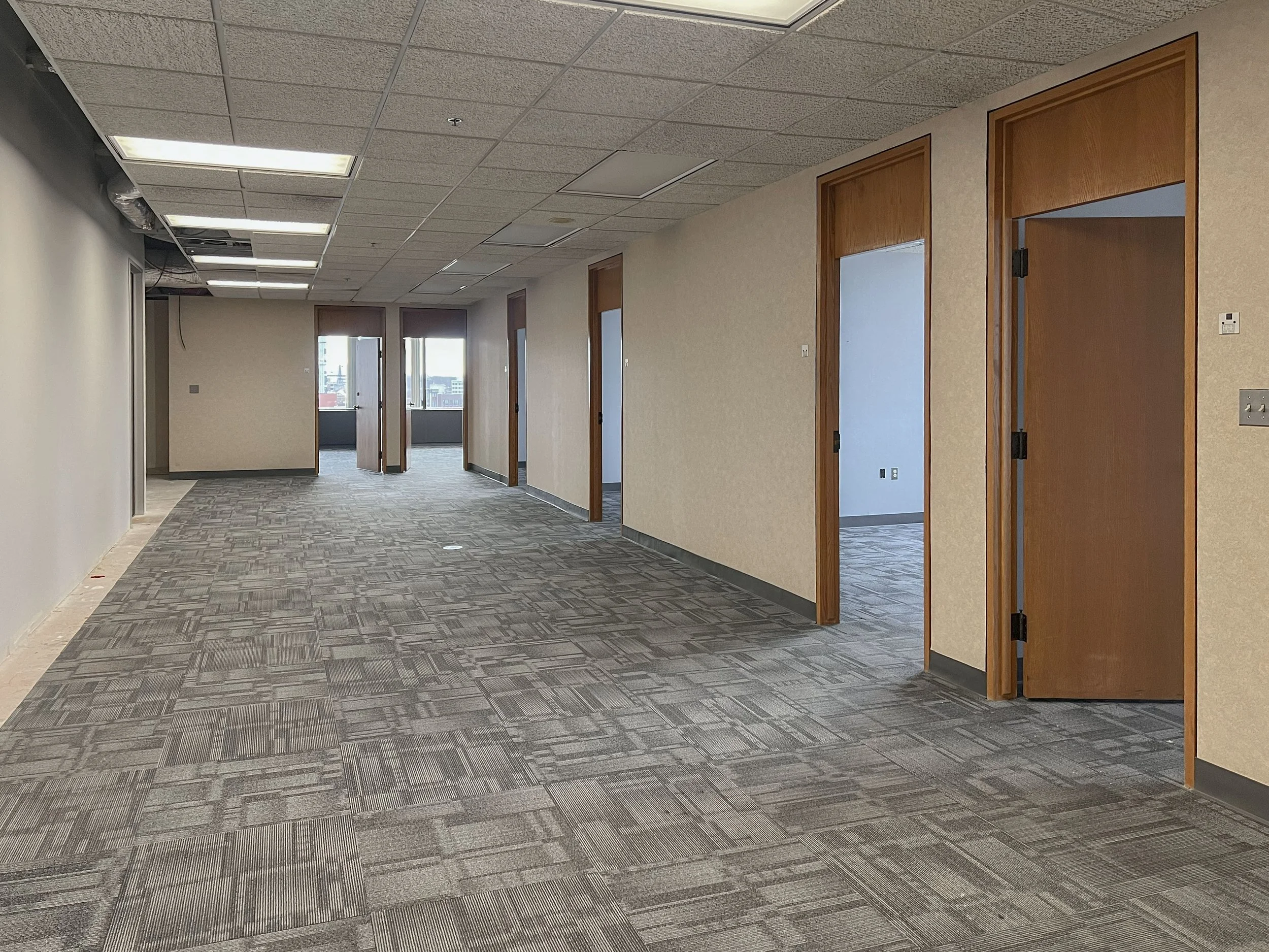 Office corridor and open workspace in Suite 1010 at 99 Monroe