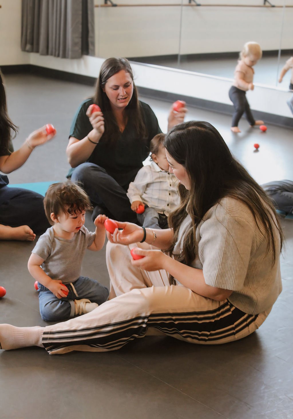 Mom and toddler with egg shakers in music class
