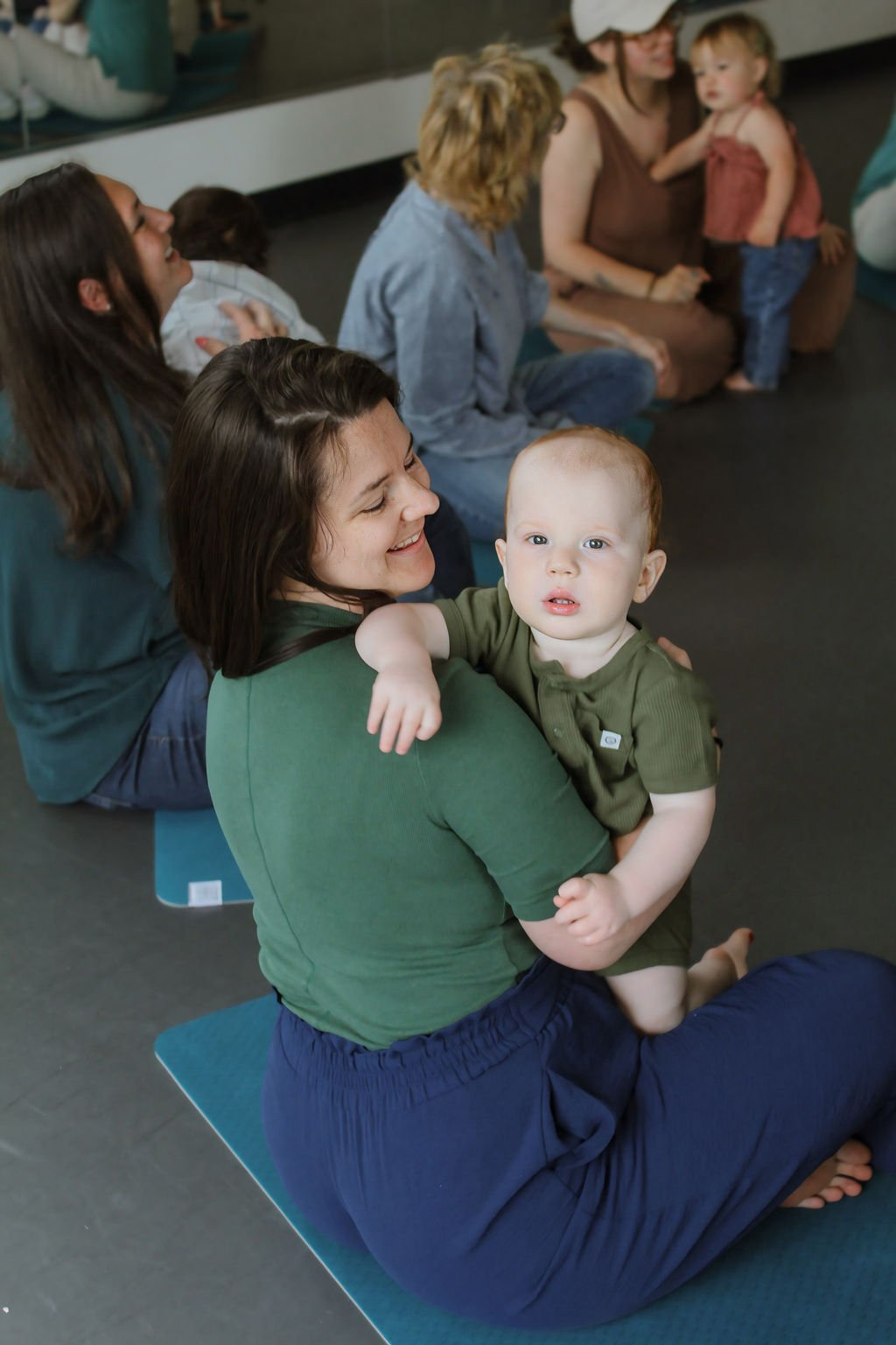 Mom smiling with baby in music class